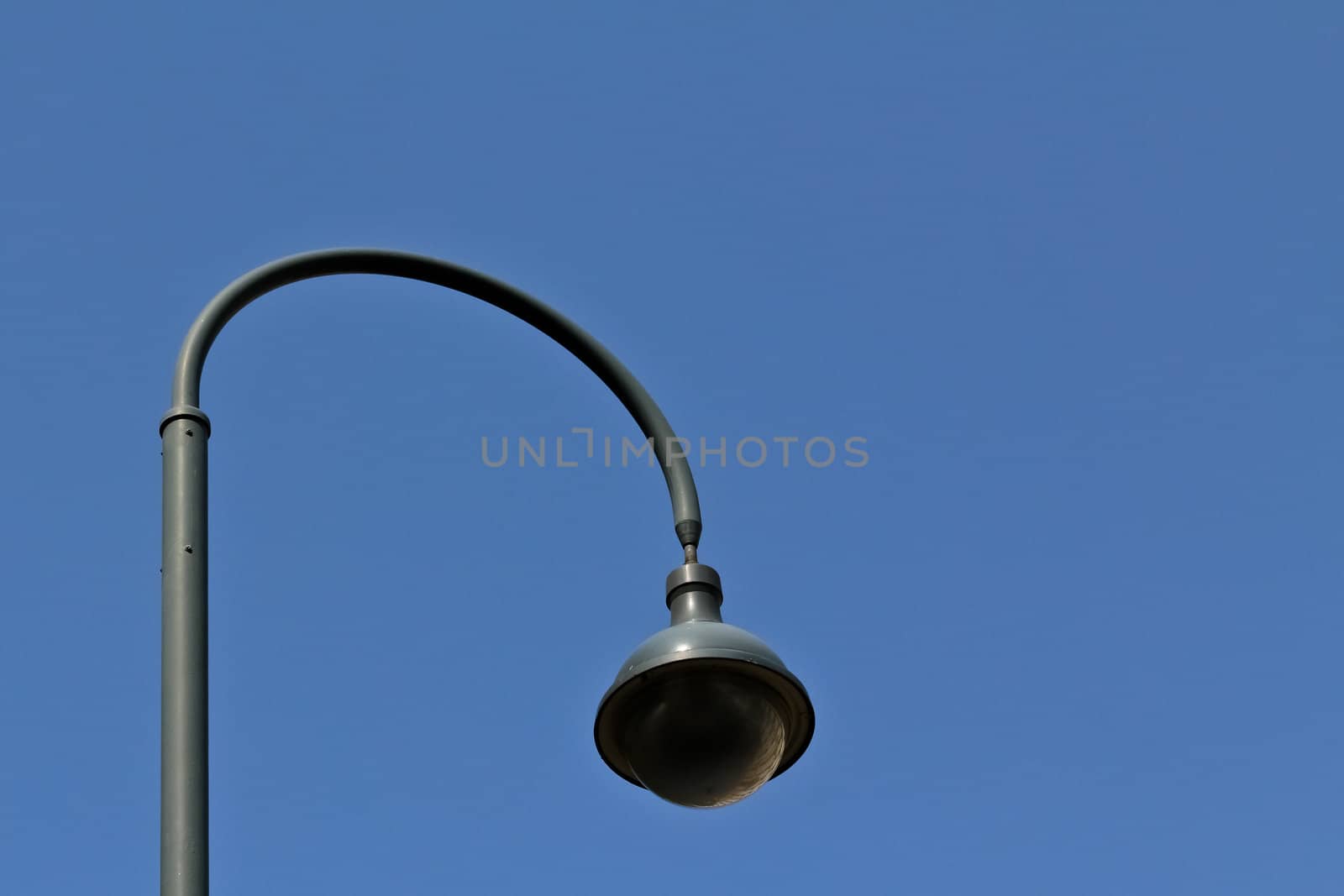 A modern street lamp on a street in Vienna with a round shape