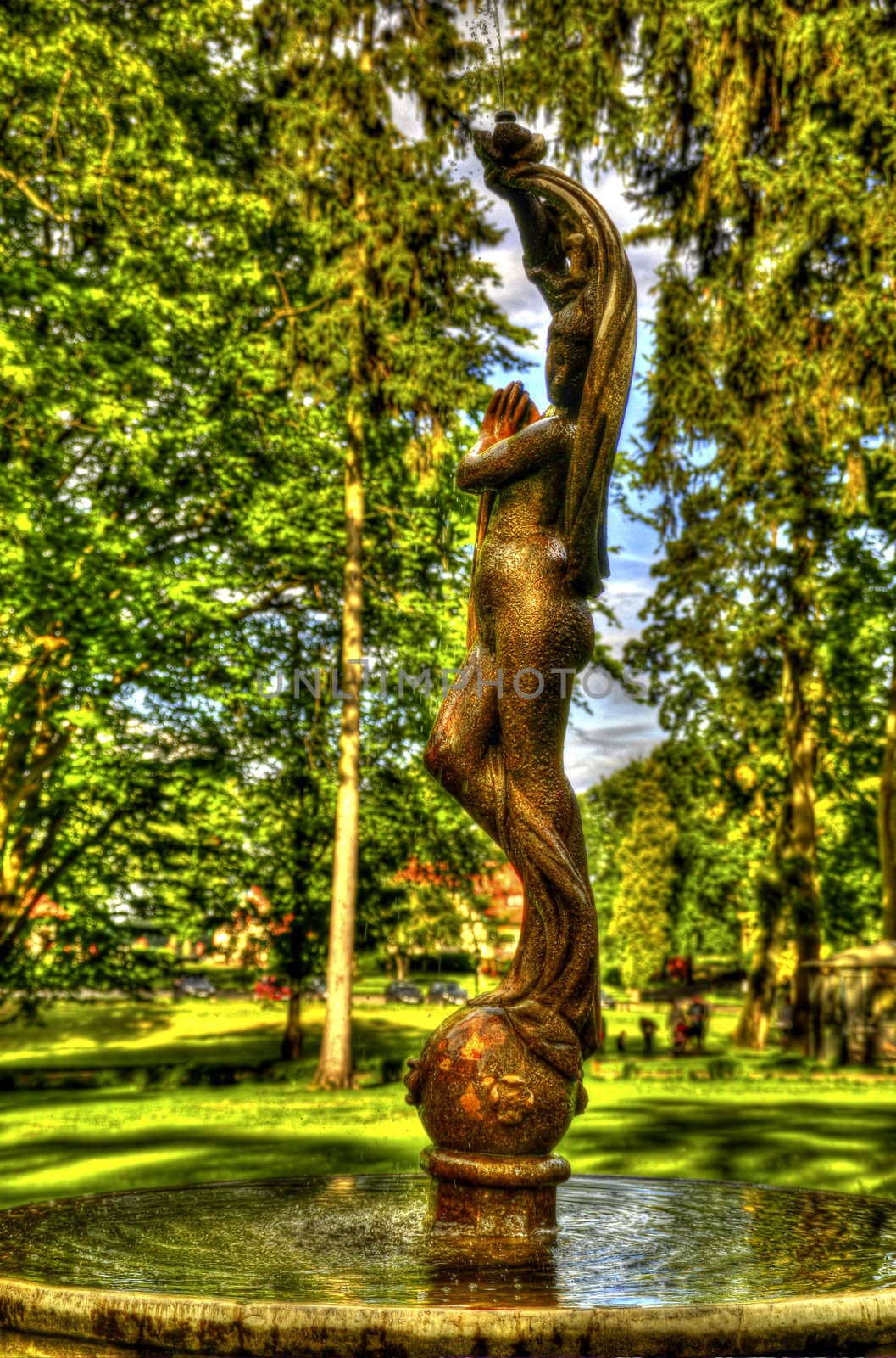 This photo present nymph on a fountain in the park HDR.