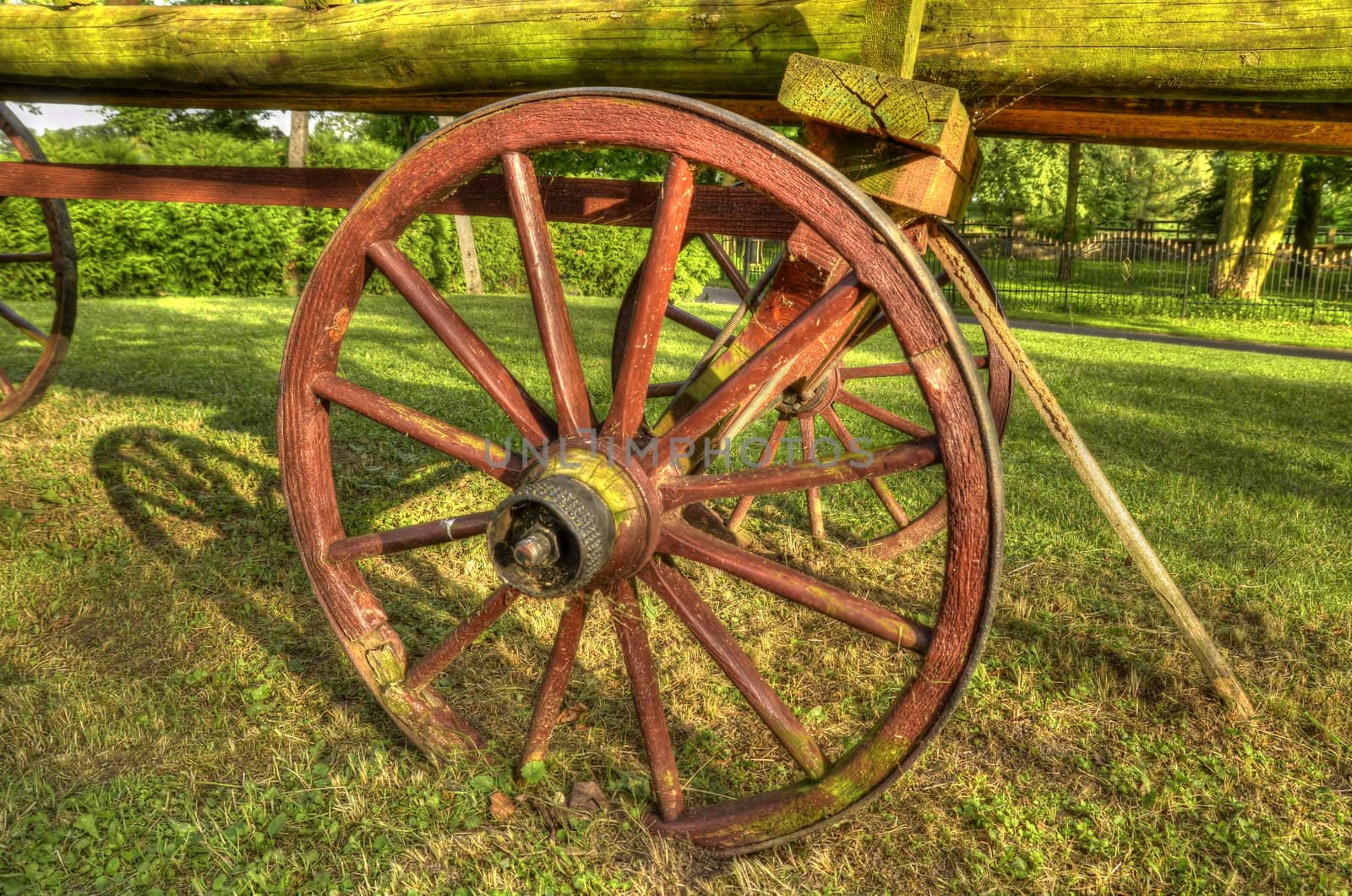This photo present old wooden wagon in the park decoration HDR.
