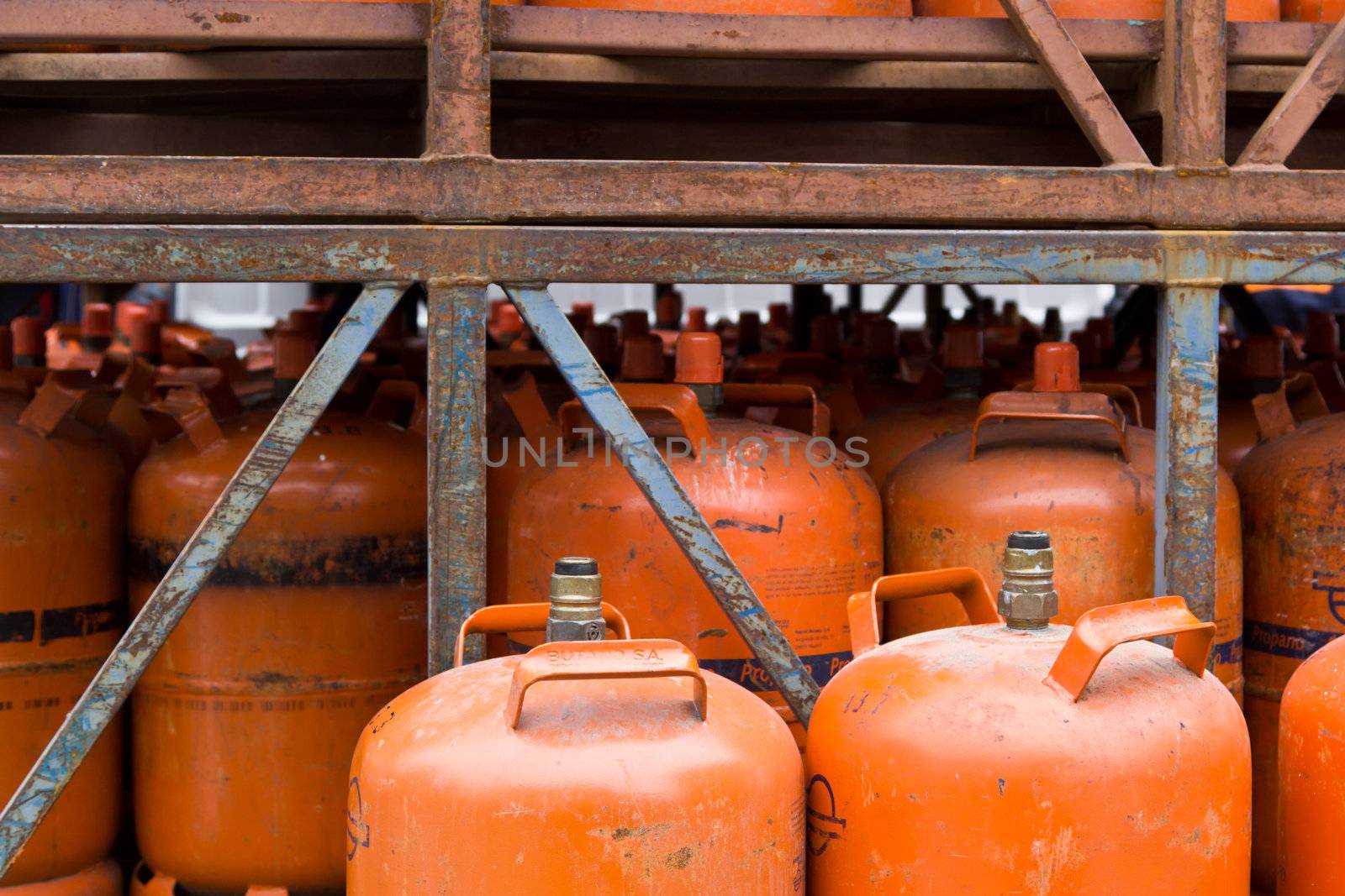 A set of stacked propane cartridges in a container