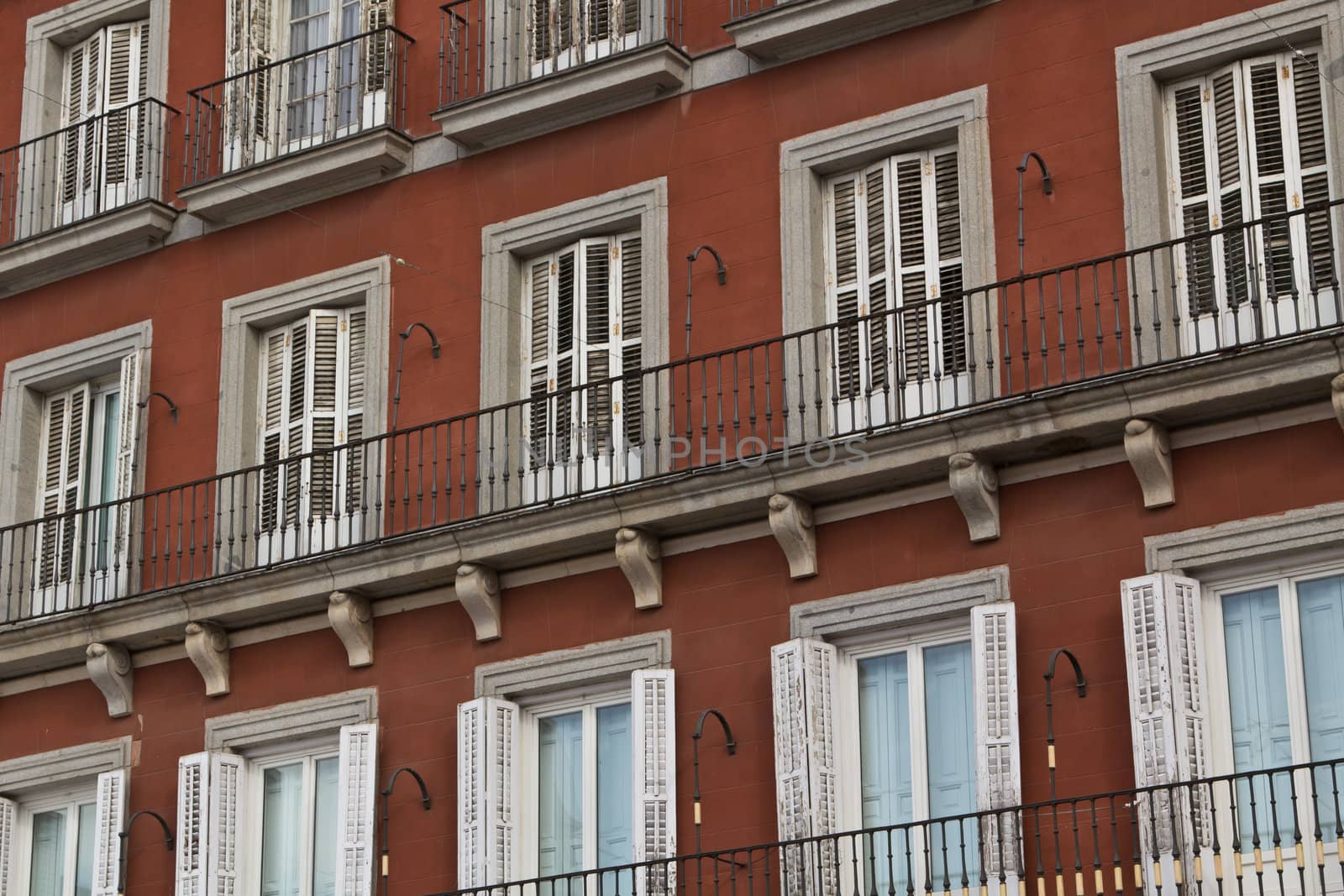 Open and closed windows on Plaza Mayor in Madrid
