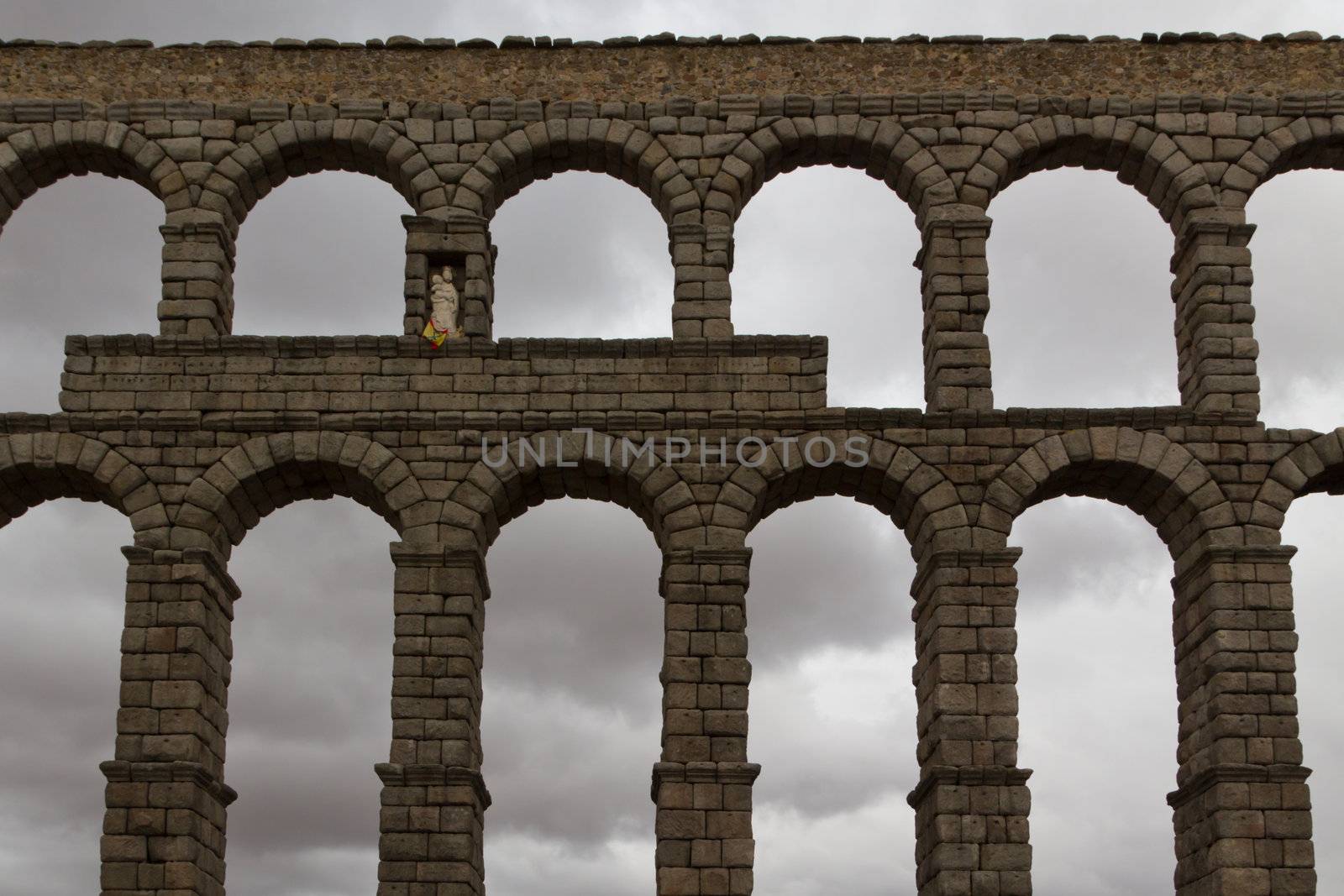 The aqueduct in Segovia in front of dark sky