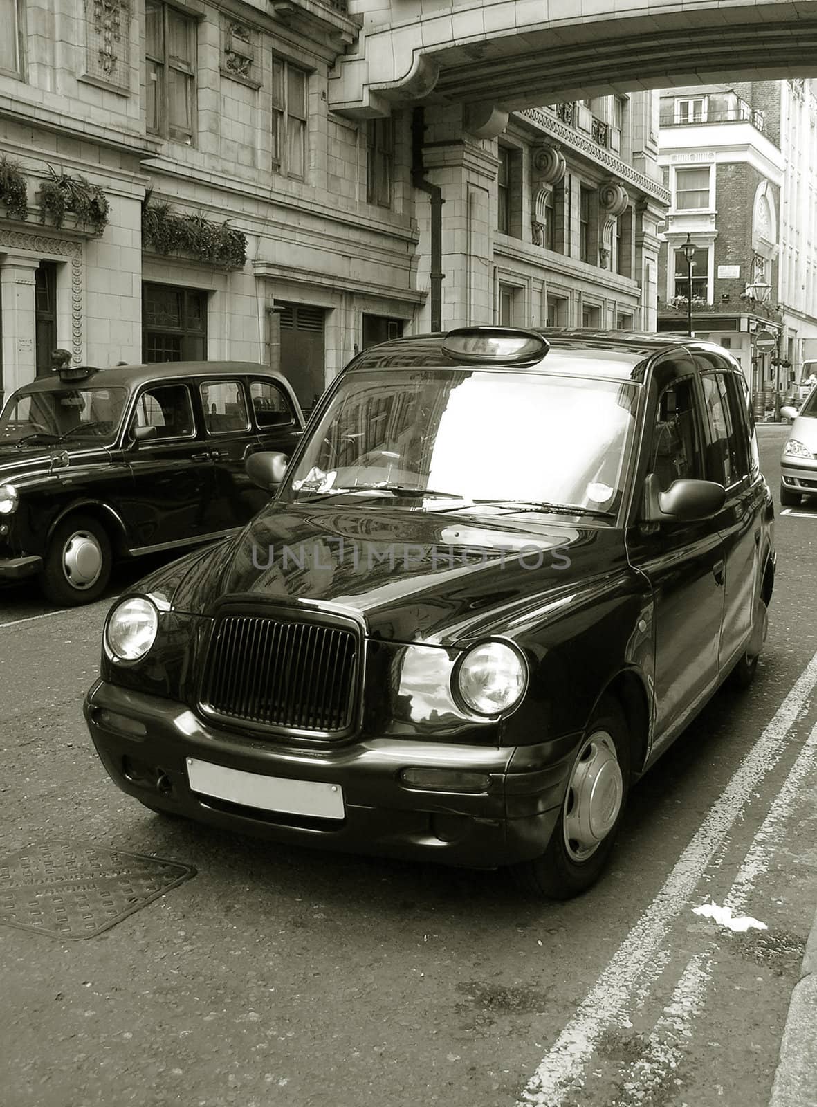 Classic London cab on the street. Old Sepia toned photo.