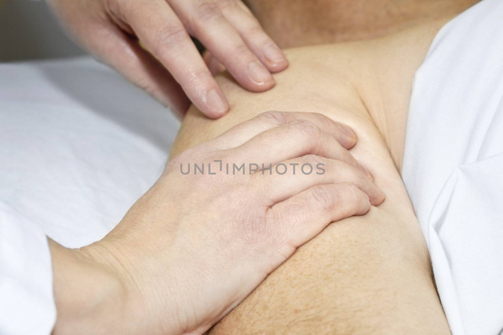 Closeup of female hands massaging arm and shoulder