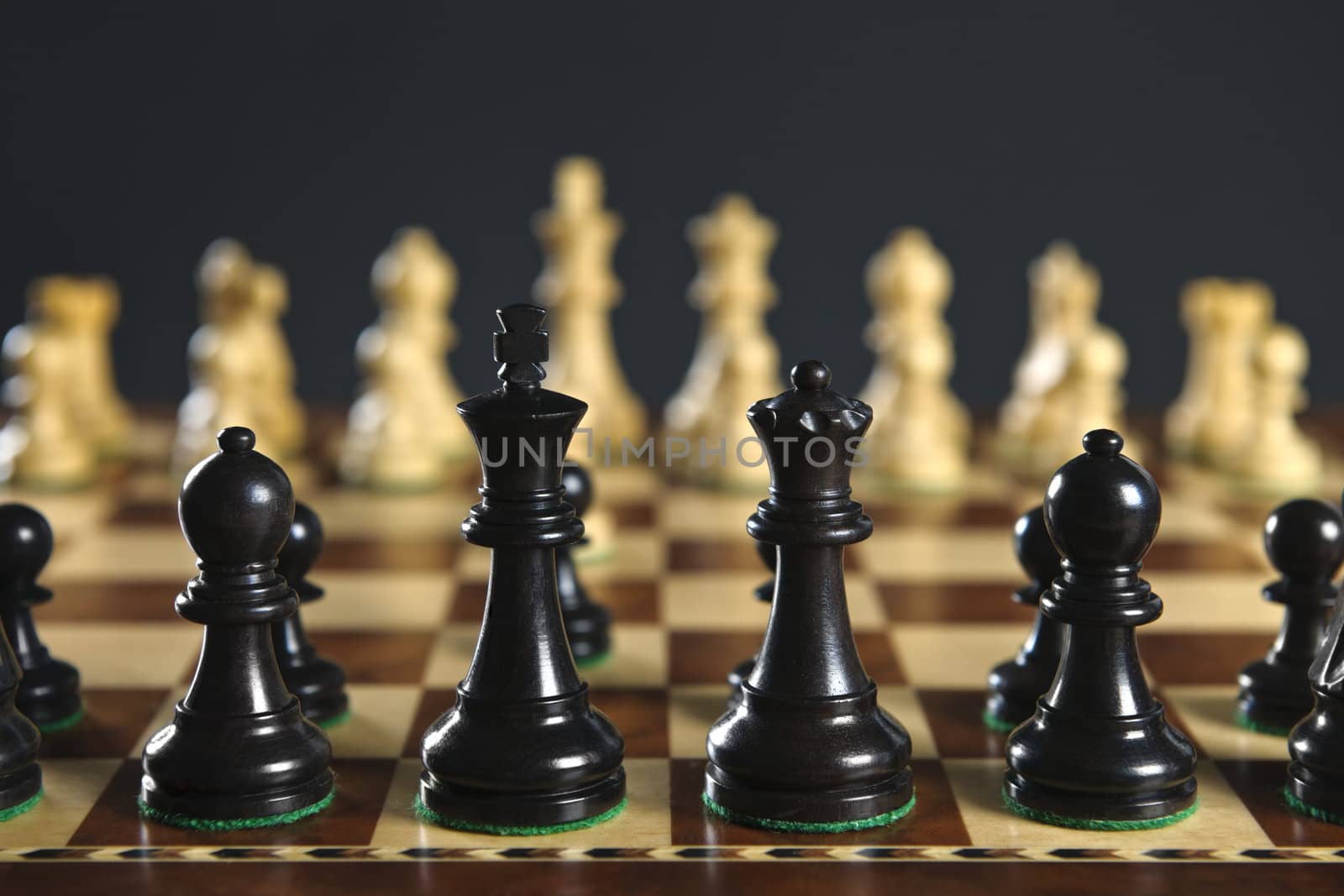 Close up of chess pieces on wooden chessboard