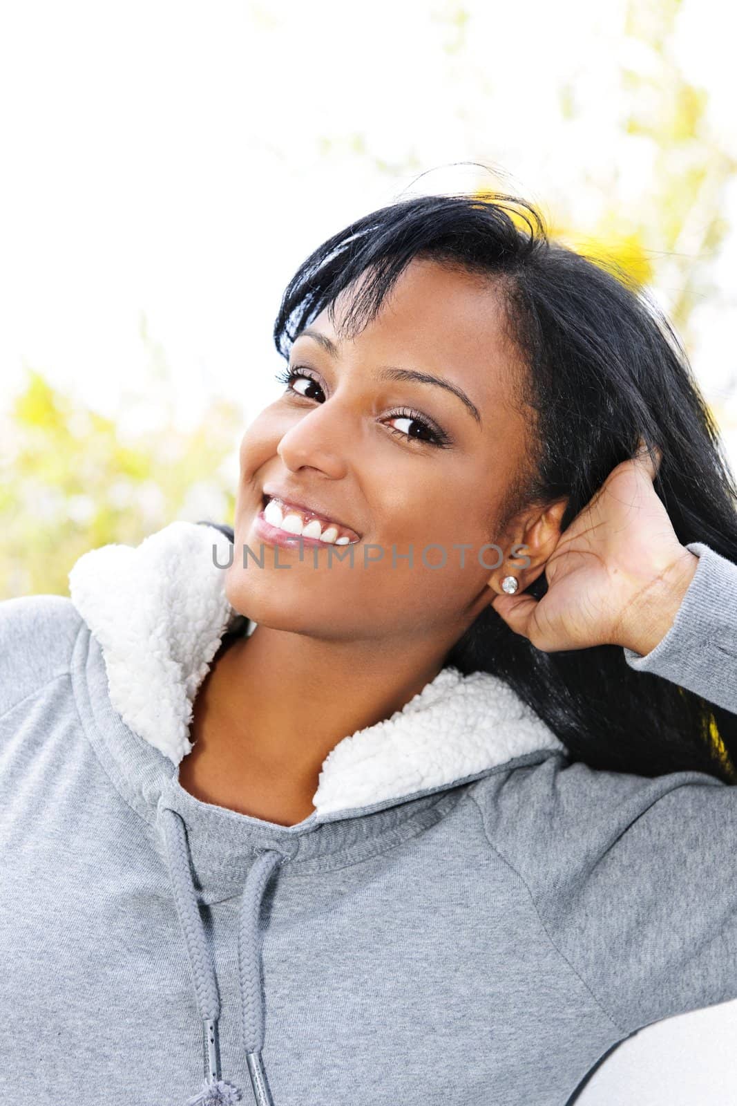 Portrait of happy young black woman outdoors in fall