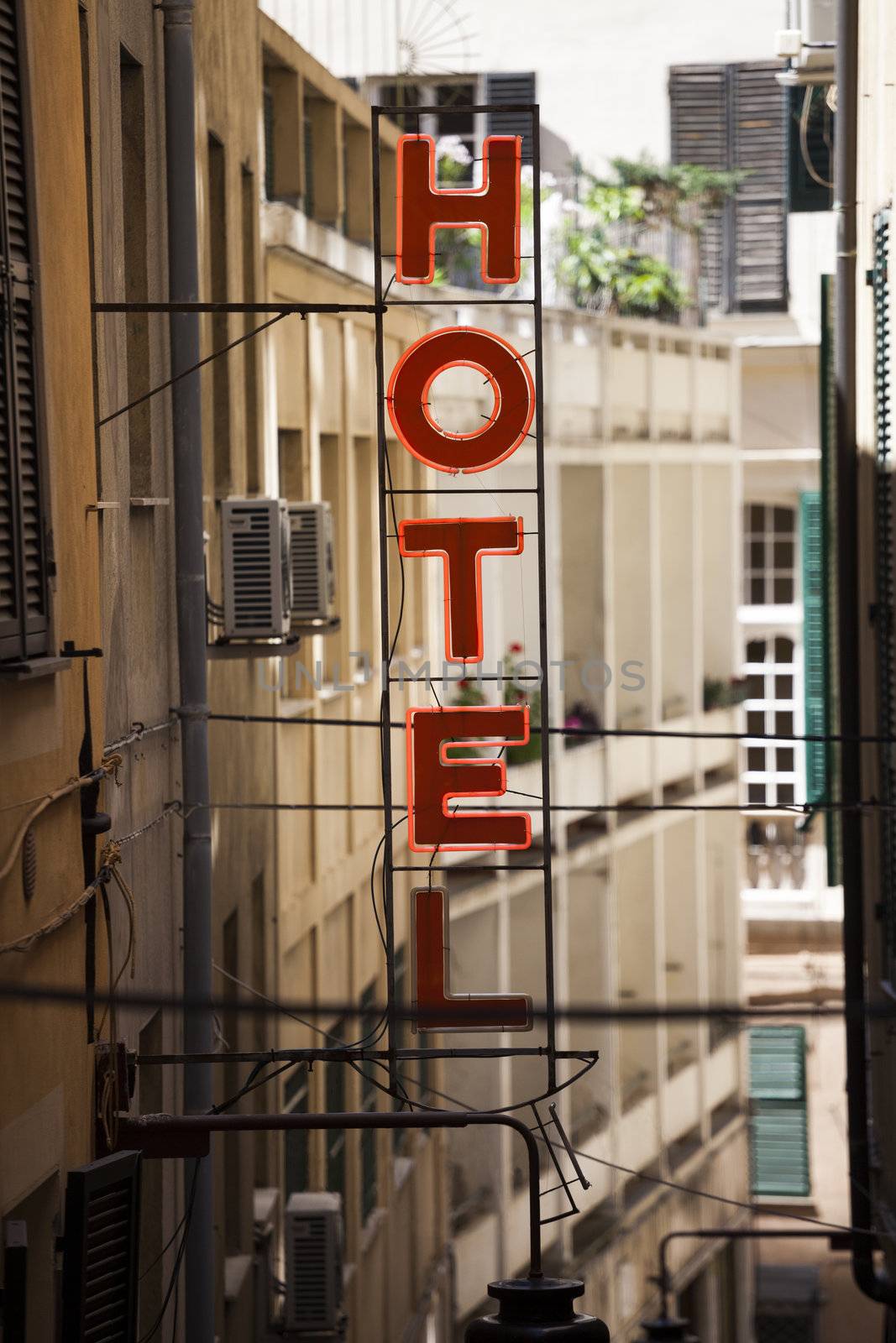 Red neon Hotel sign in old town