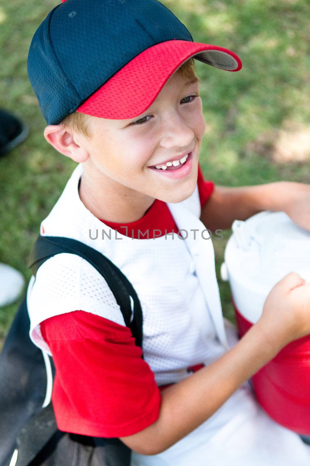 Little league baseball player happy after winning the game.