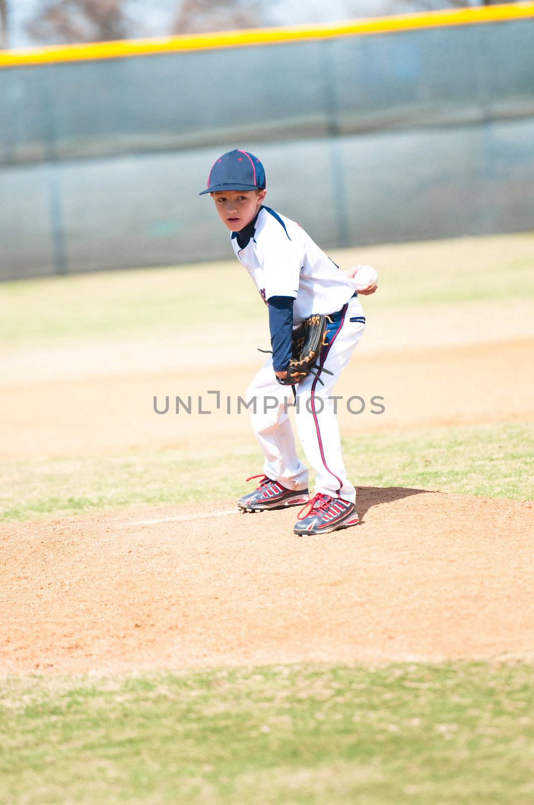 Little league baseball player about to pitch.