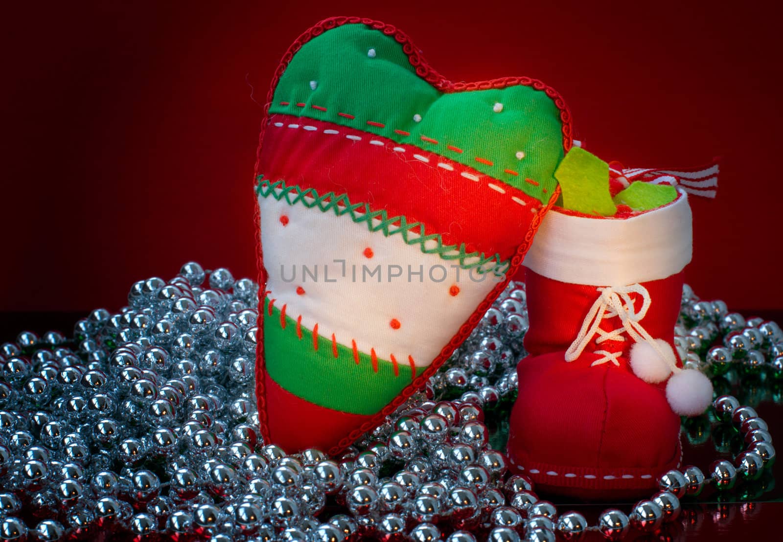 Christmas decorations with silver beads on red background 