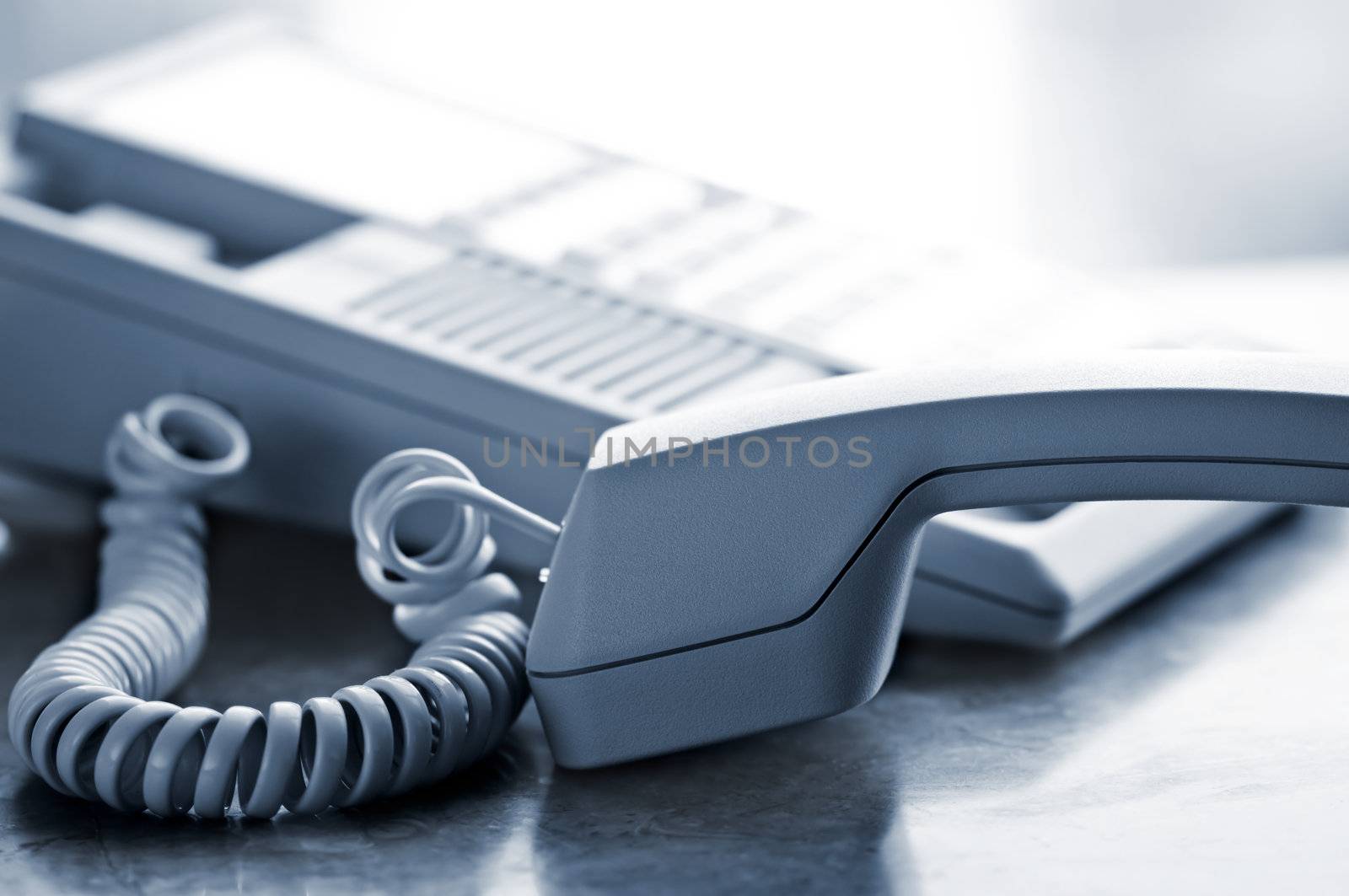 Telephone handset off the hook on desk