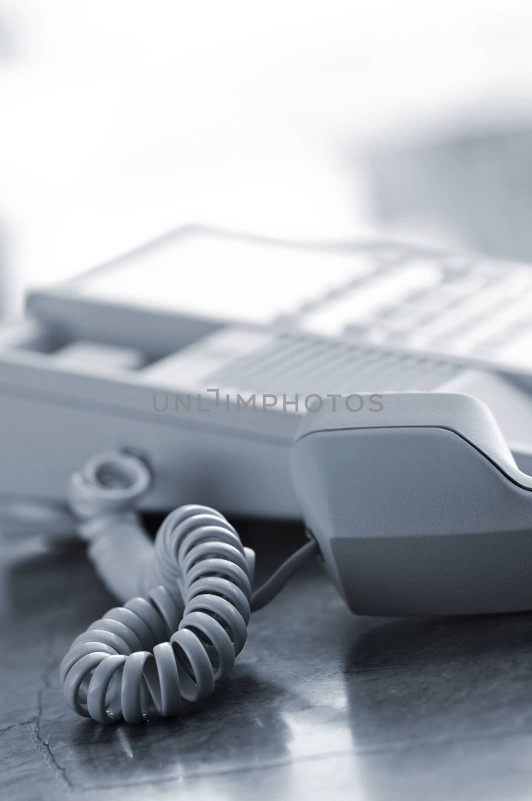 Telephone handset off the hook on desk