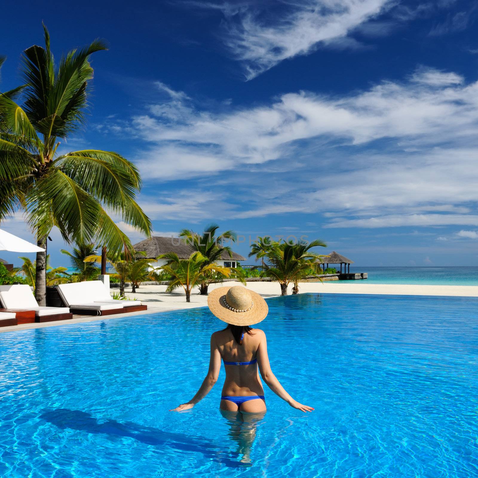 Woman in hat at the pool 