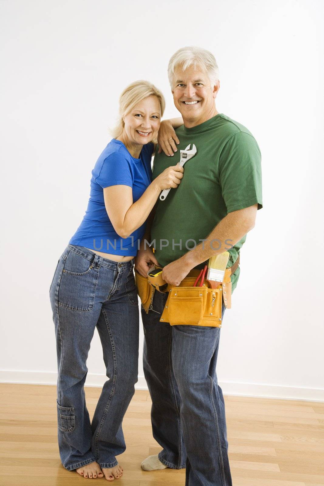 Middle-aged couple with household tools.