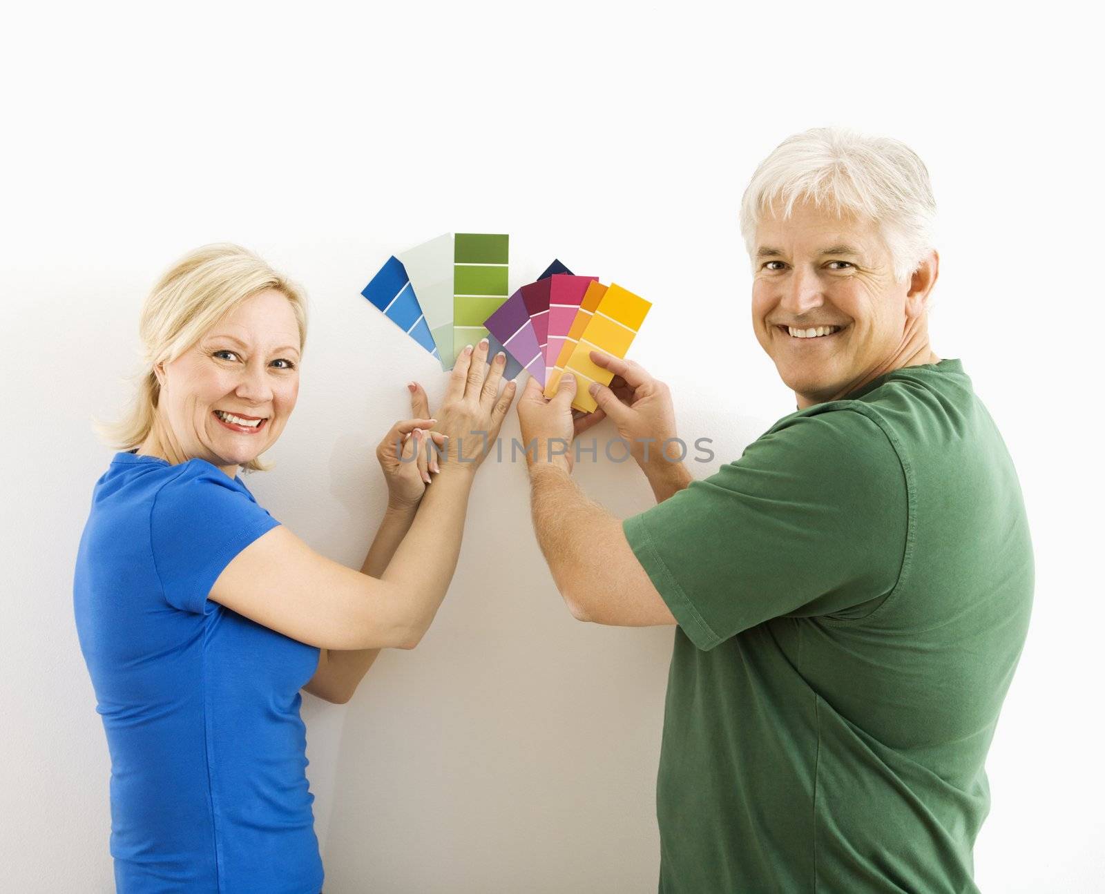 Man and woman comparing swatches. by iofoto
