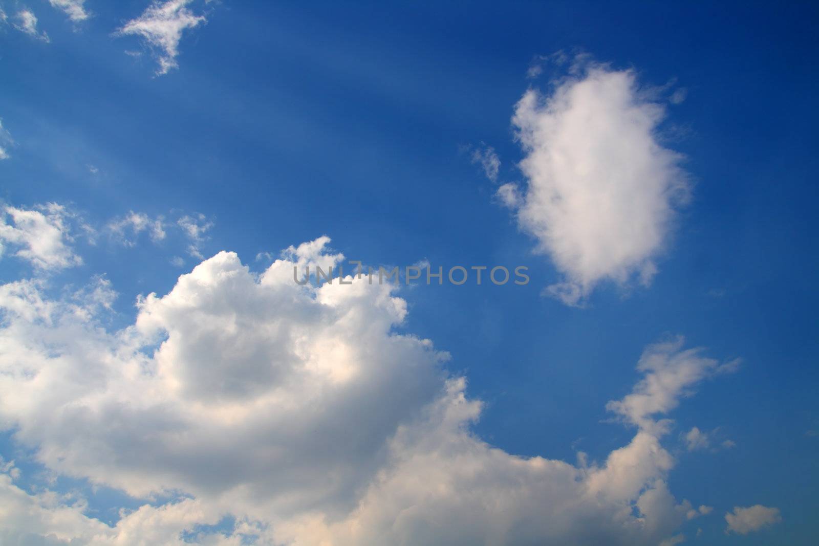 deep blue sky with clouds and sun rays background