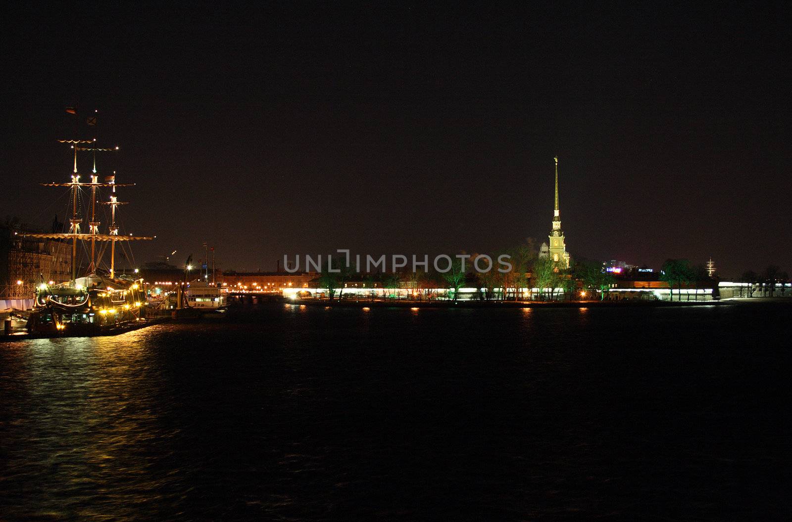 night view on illuminated ship and "petropavlovskaya krepost" in Saint Petersburg, Russia
