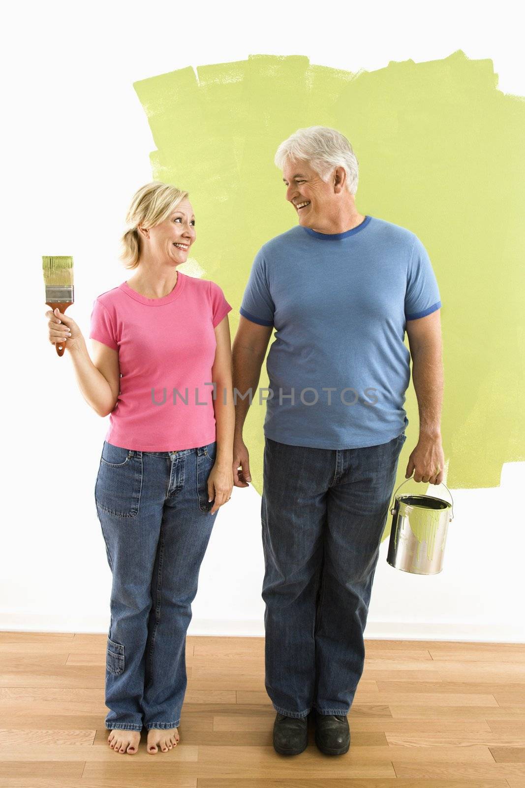 Couple with painting supplies. by iofoto