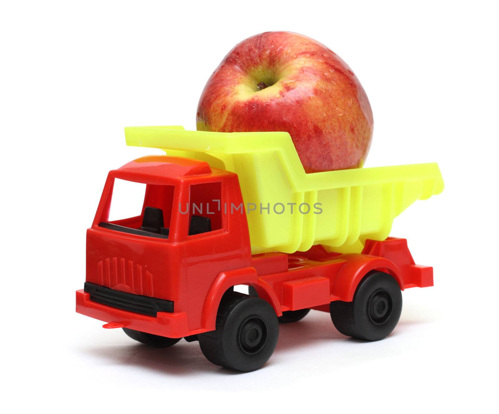 food transportation concept - toy lorry with apple by Mikko