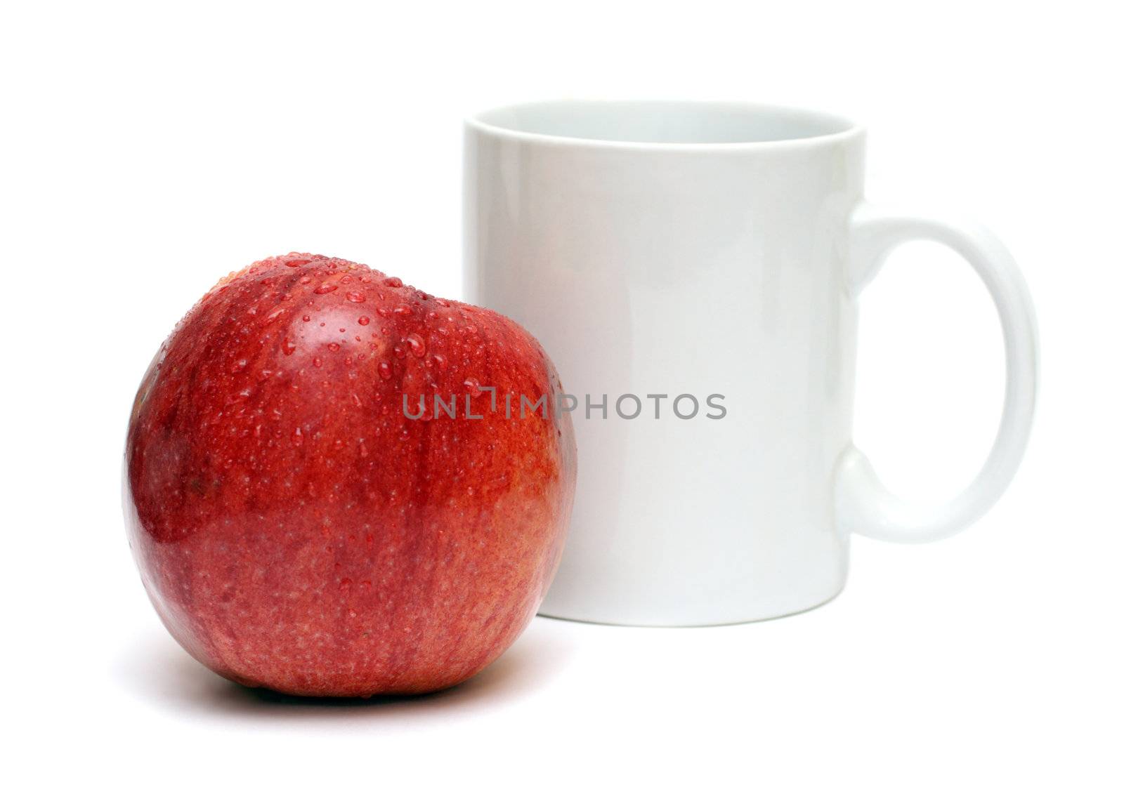 red apple and white mug isolated on white