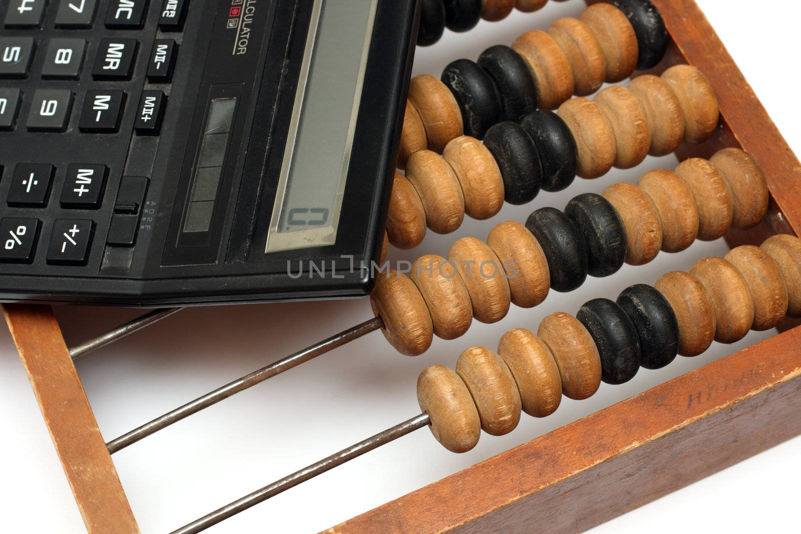 old wooden abacus and electronic calculator close-up