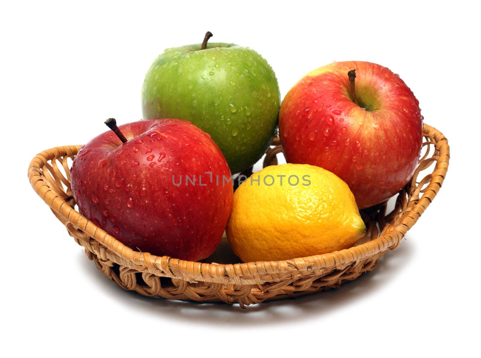 basket with wet fruits isolated on white