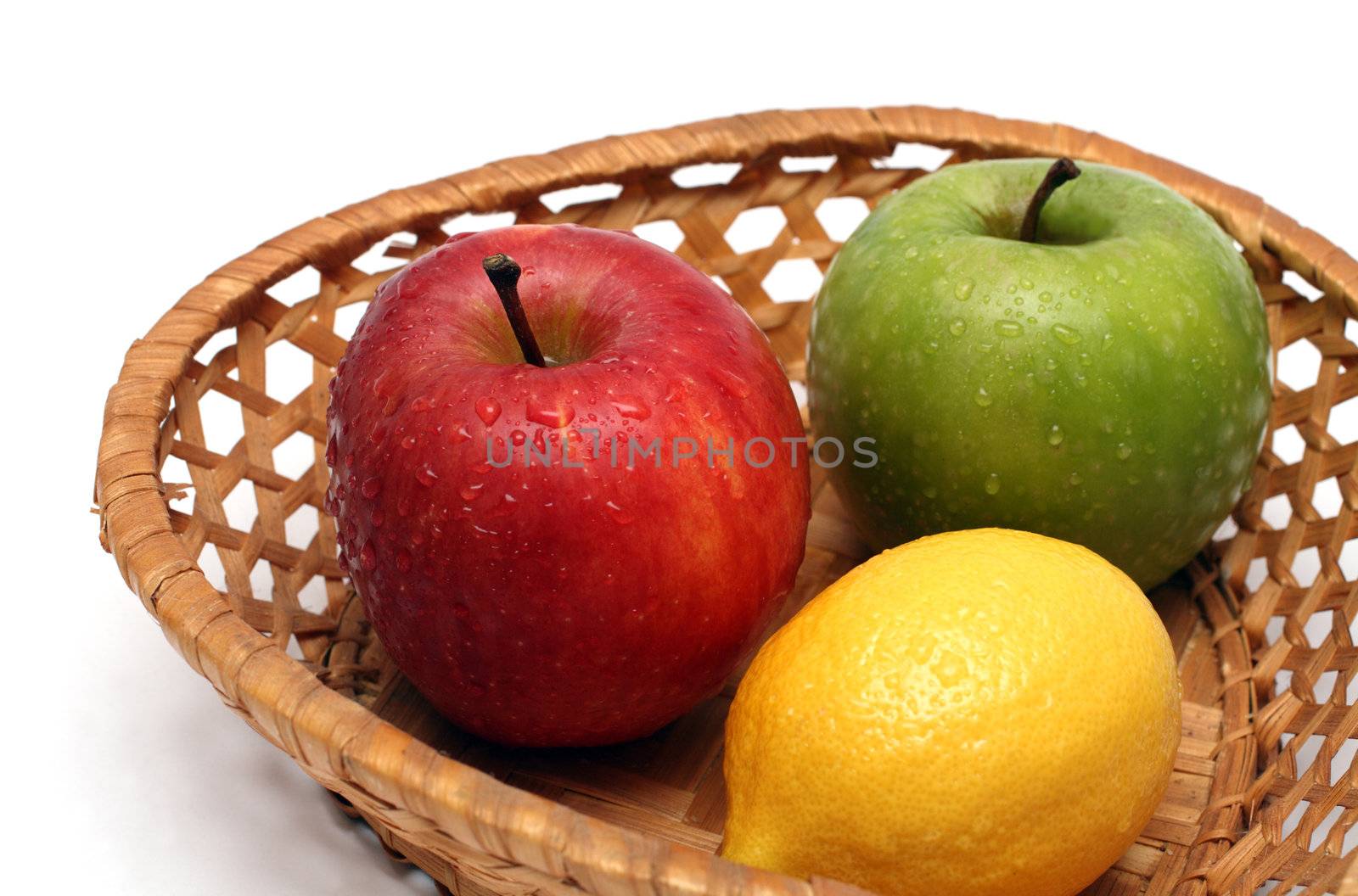 basket with wet fruits isolated on white