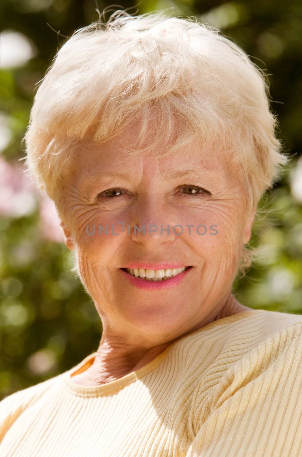The elderly woman smiles
