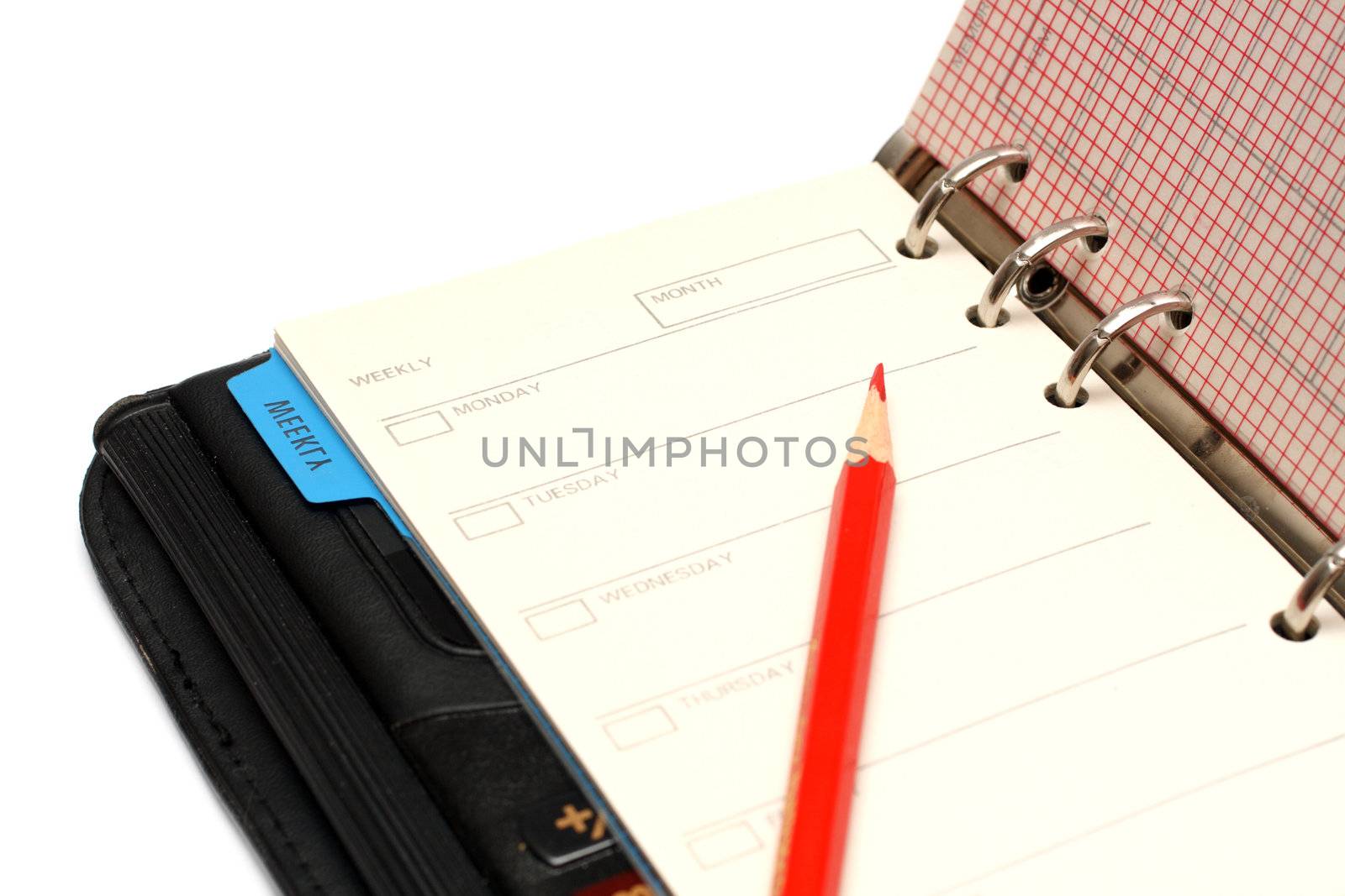 part of open black organizer and red pencil with copyspace