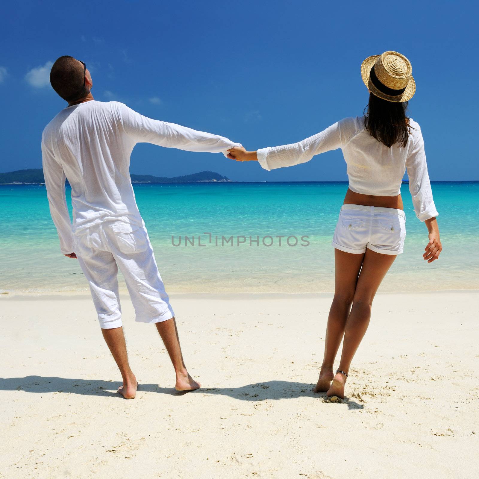 Couple in white on a tropical beach