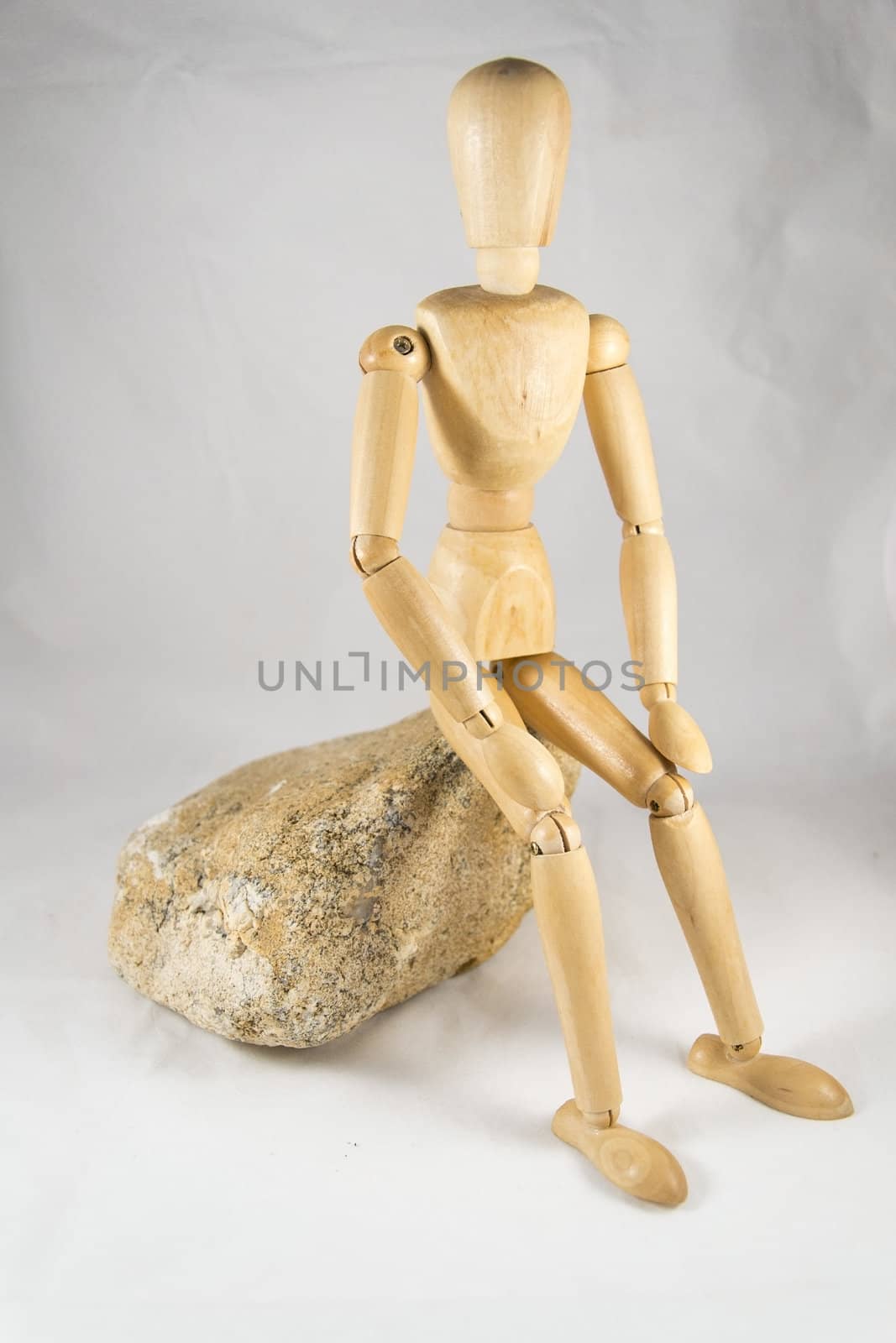 dummy sitting on a rock by itanu