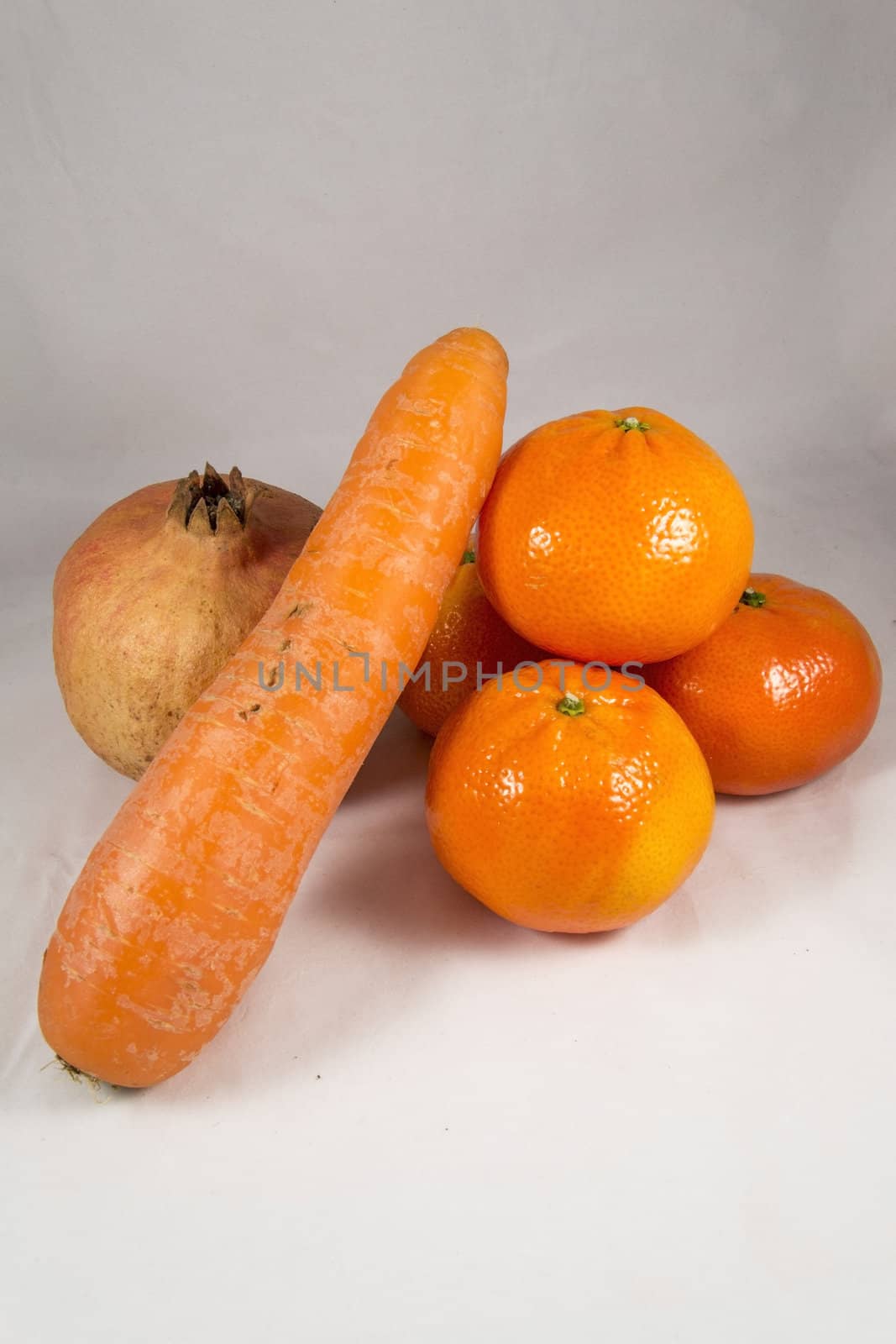 Vegetables and fruit composition. mandarine carrot and pomegranade