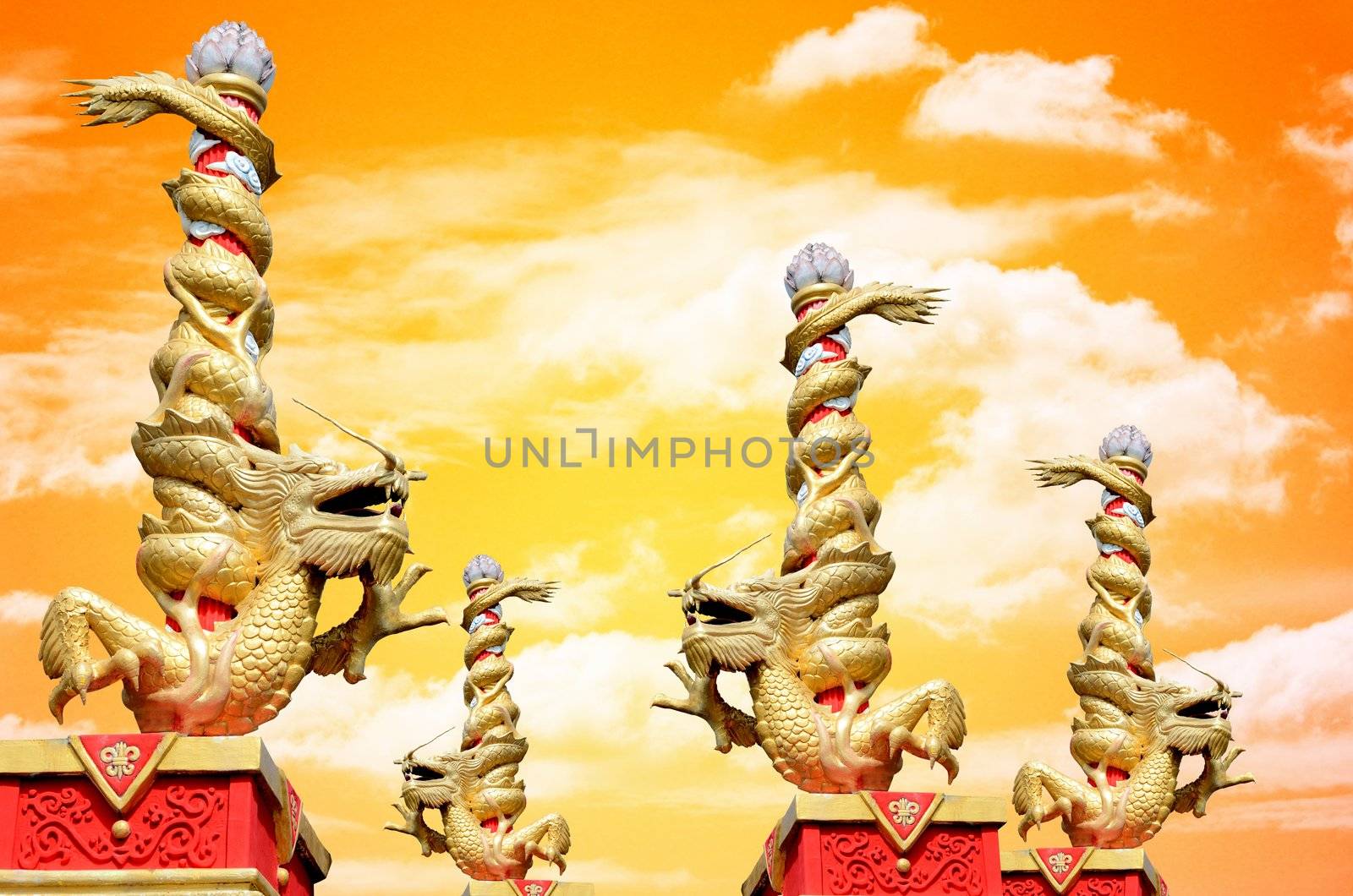 Dragon statue roll the column with sunset sky background