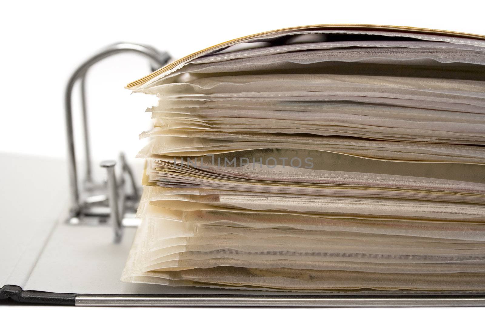 Open ring binder full of documents isolated on a white background.