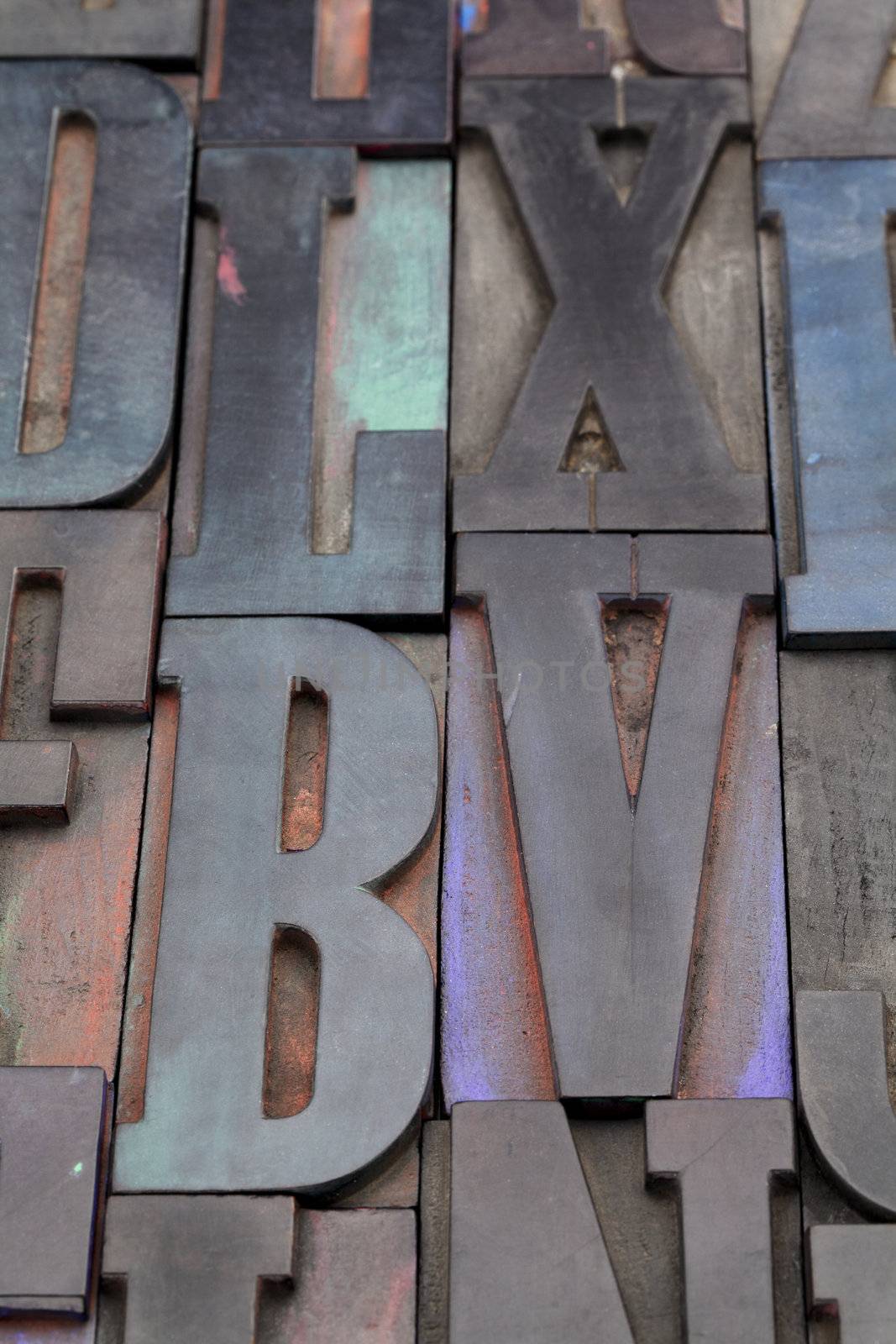 antique wood letterpress printing blocks with color ink patina, random collection with L, X, V, and B letters
