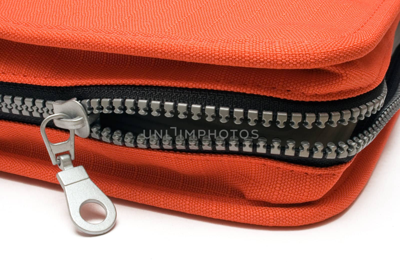 Opening the zipper of a red bag. Isolated on a white background.