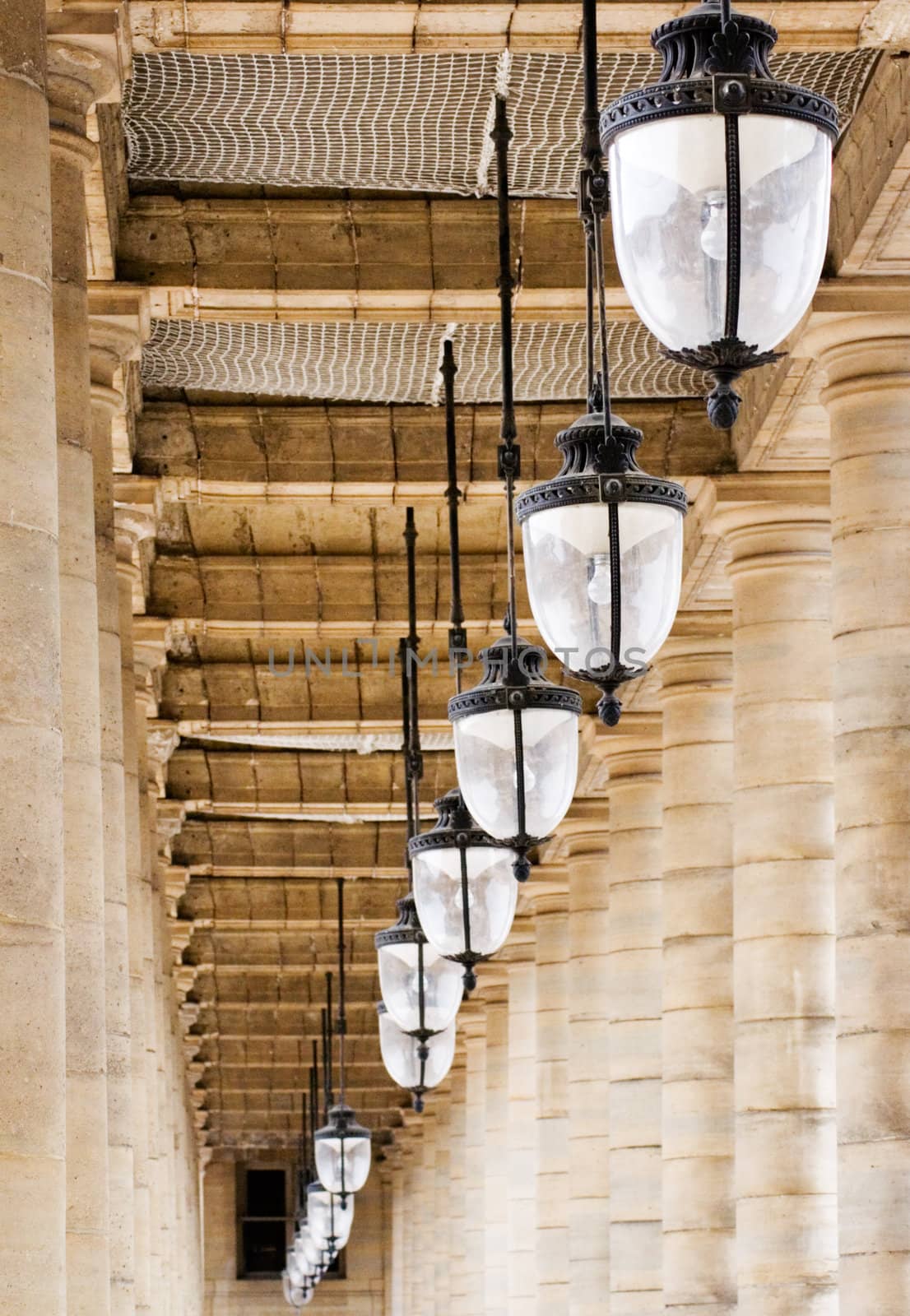 Old archway with hanging lamps.