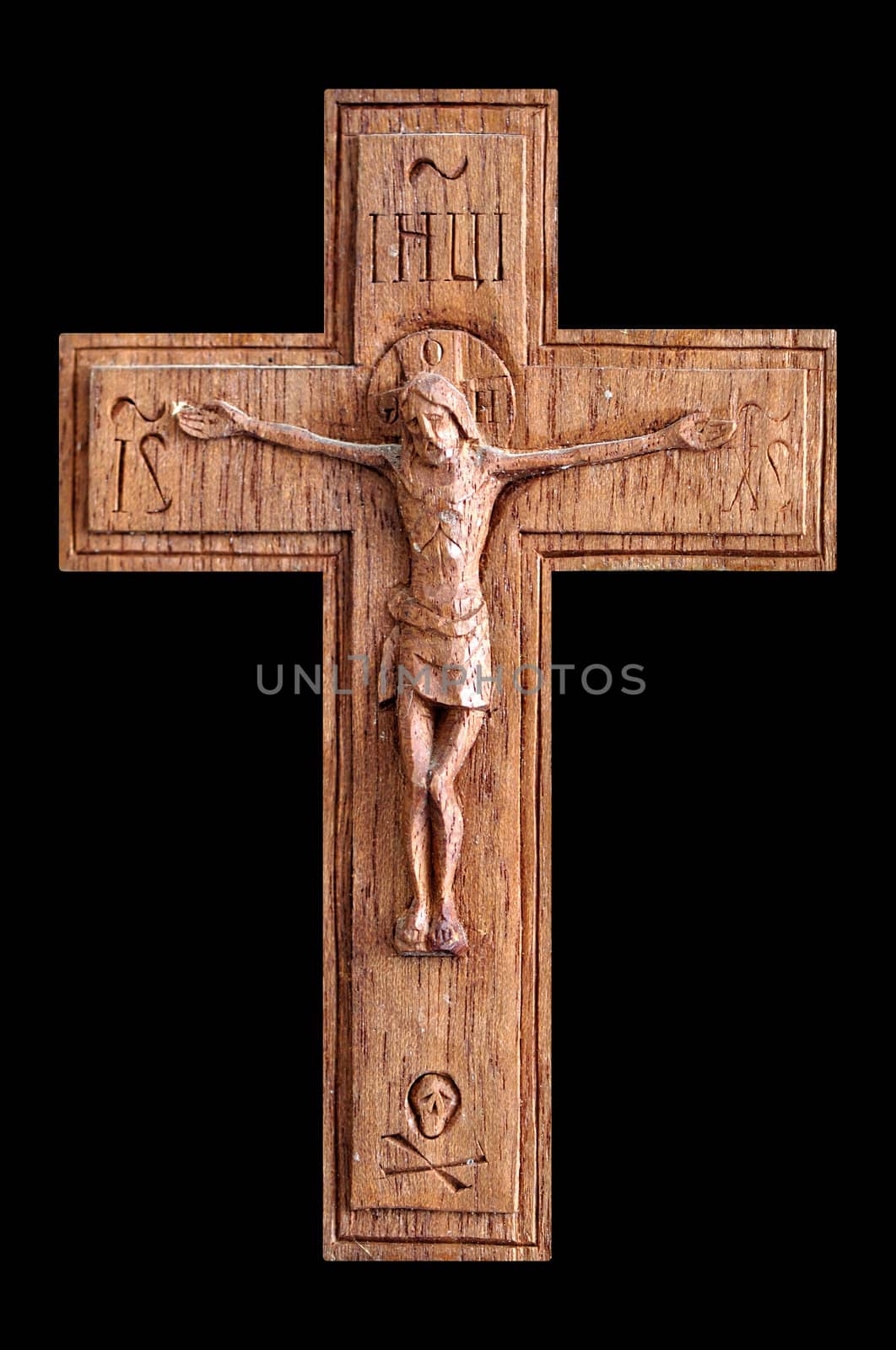 Wooden crucifix with skull and crossbones isolated on black background.