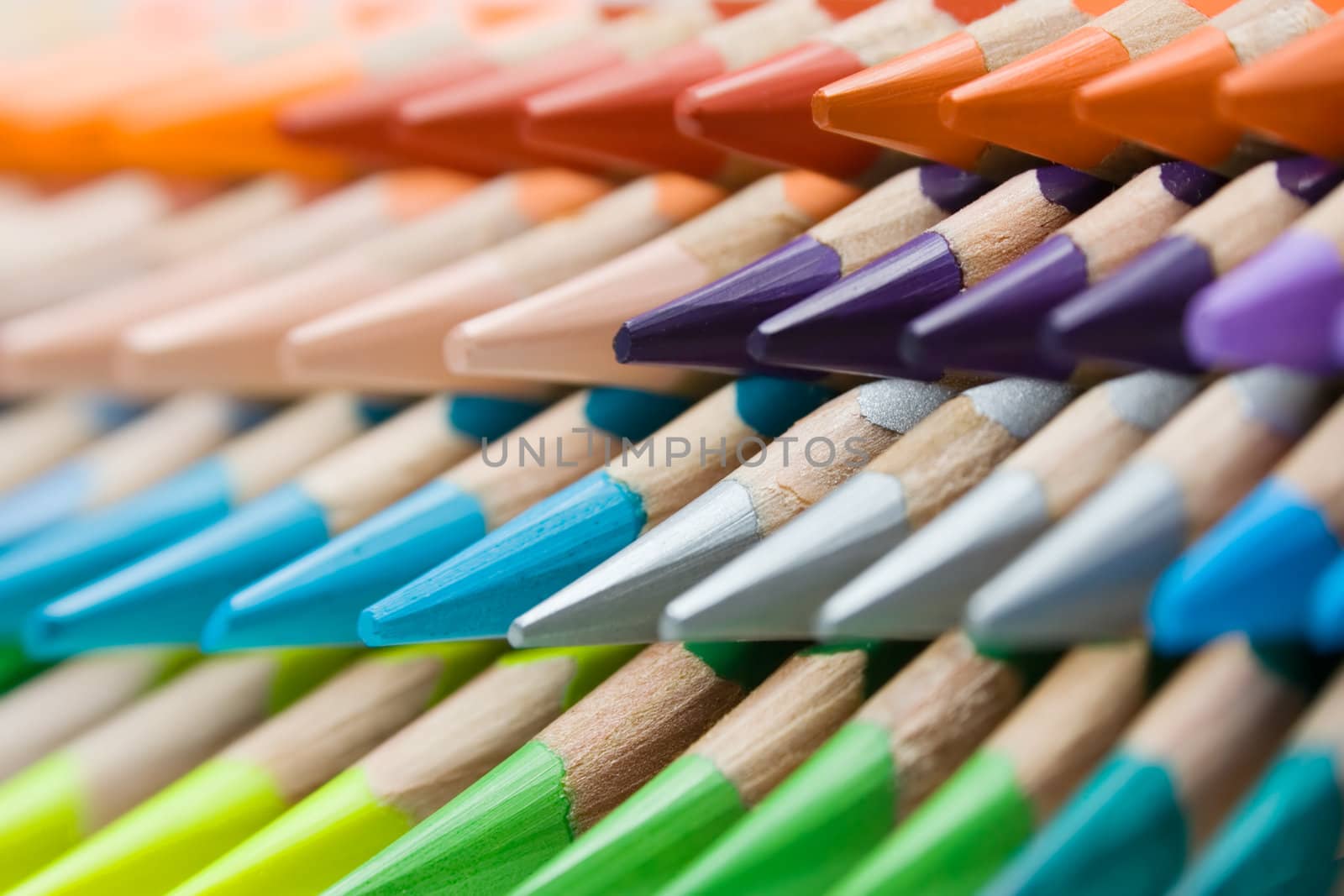 Abstract shot of stacked colored pencils. Shallow depth of field.