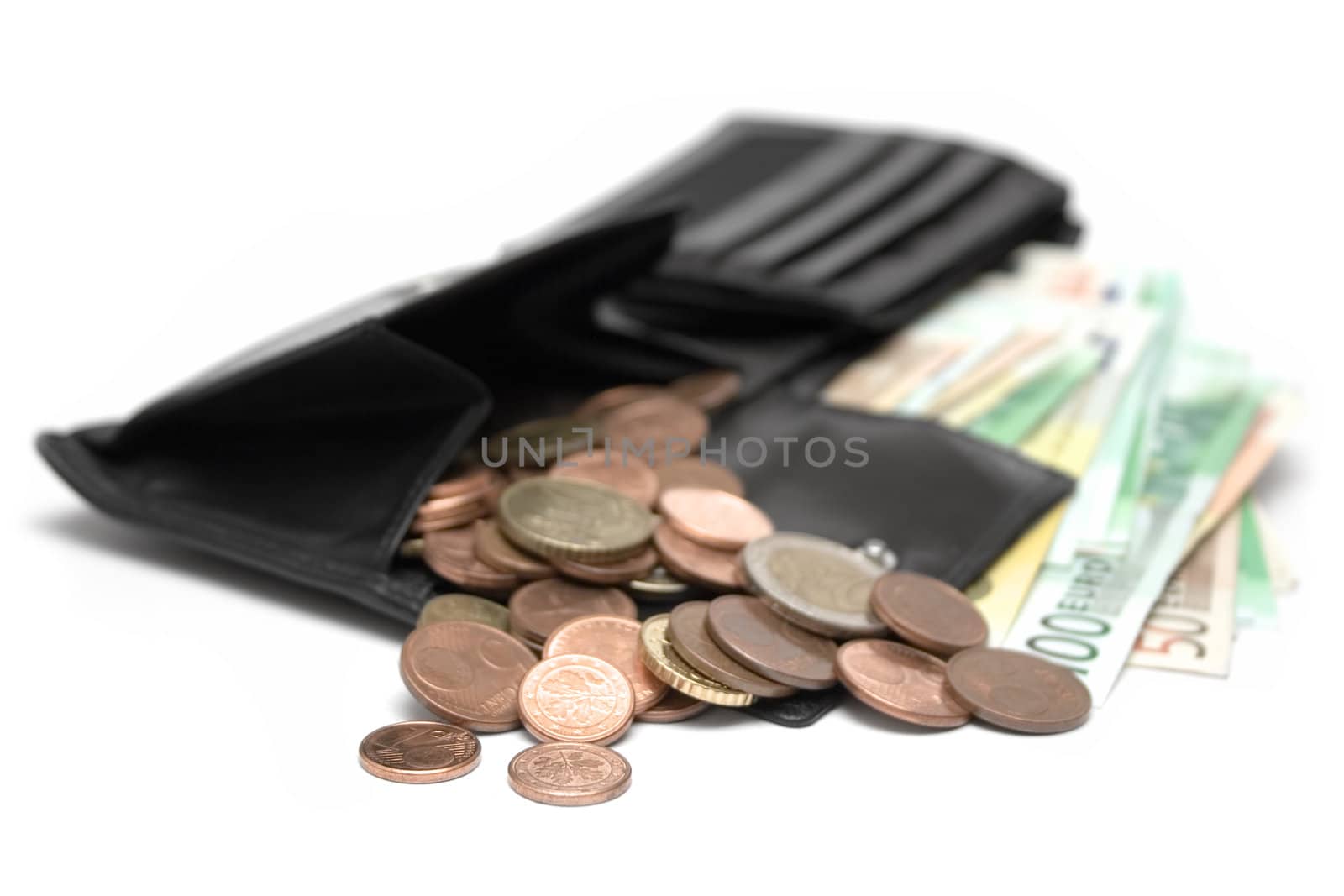 Black leather purse full of coins and banknotes. Isolated on a white background. Shallow depth of field.