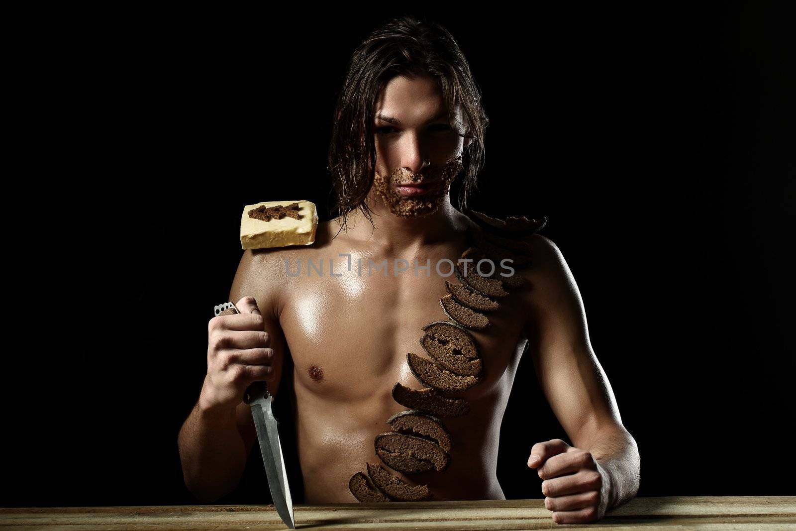 Art photo of young man with beard of bread isolated over black background