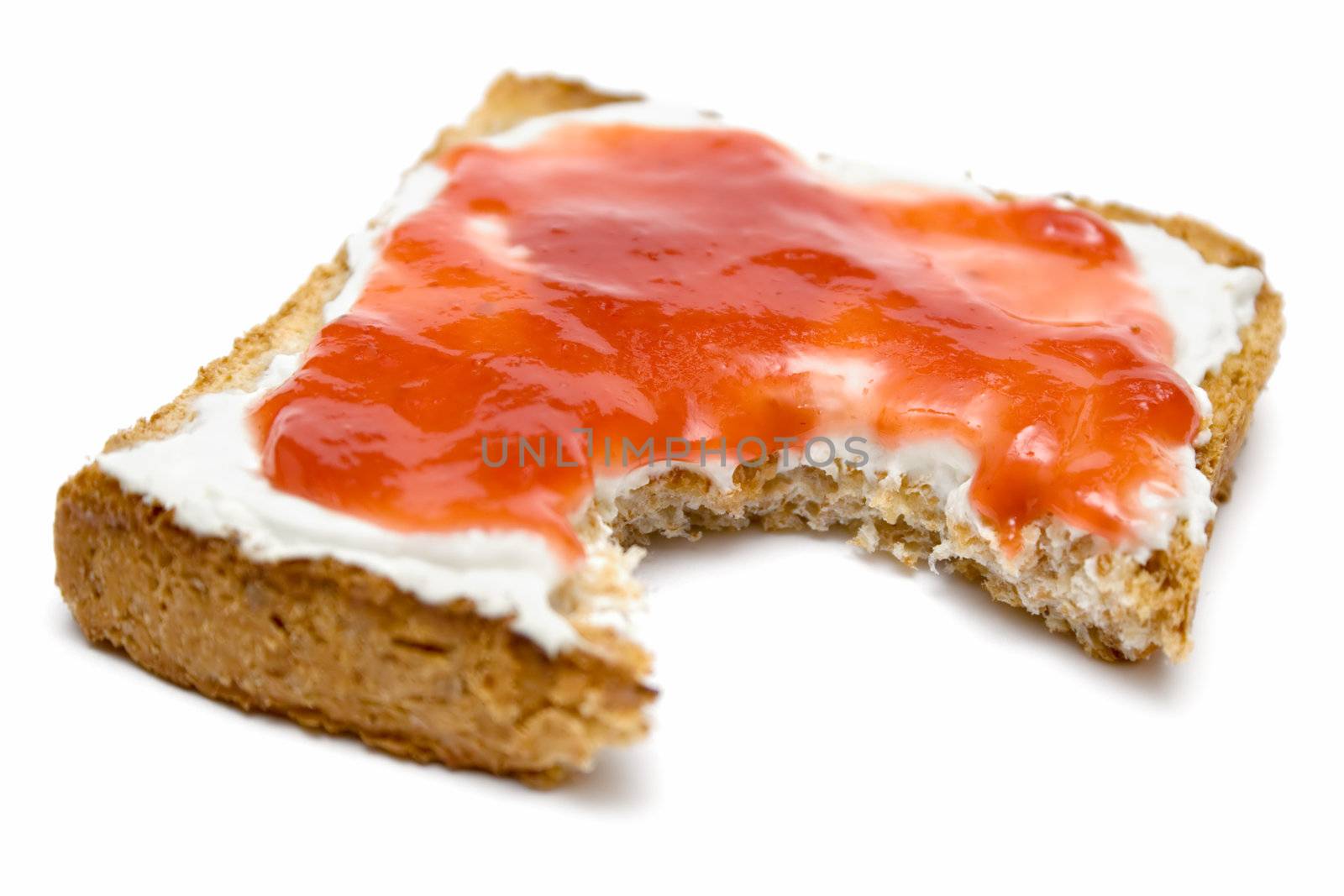 Eating a toast with butter and jam. Isolated on a white background.