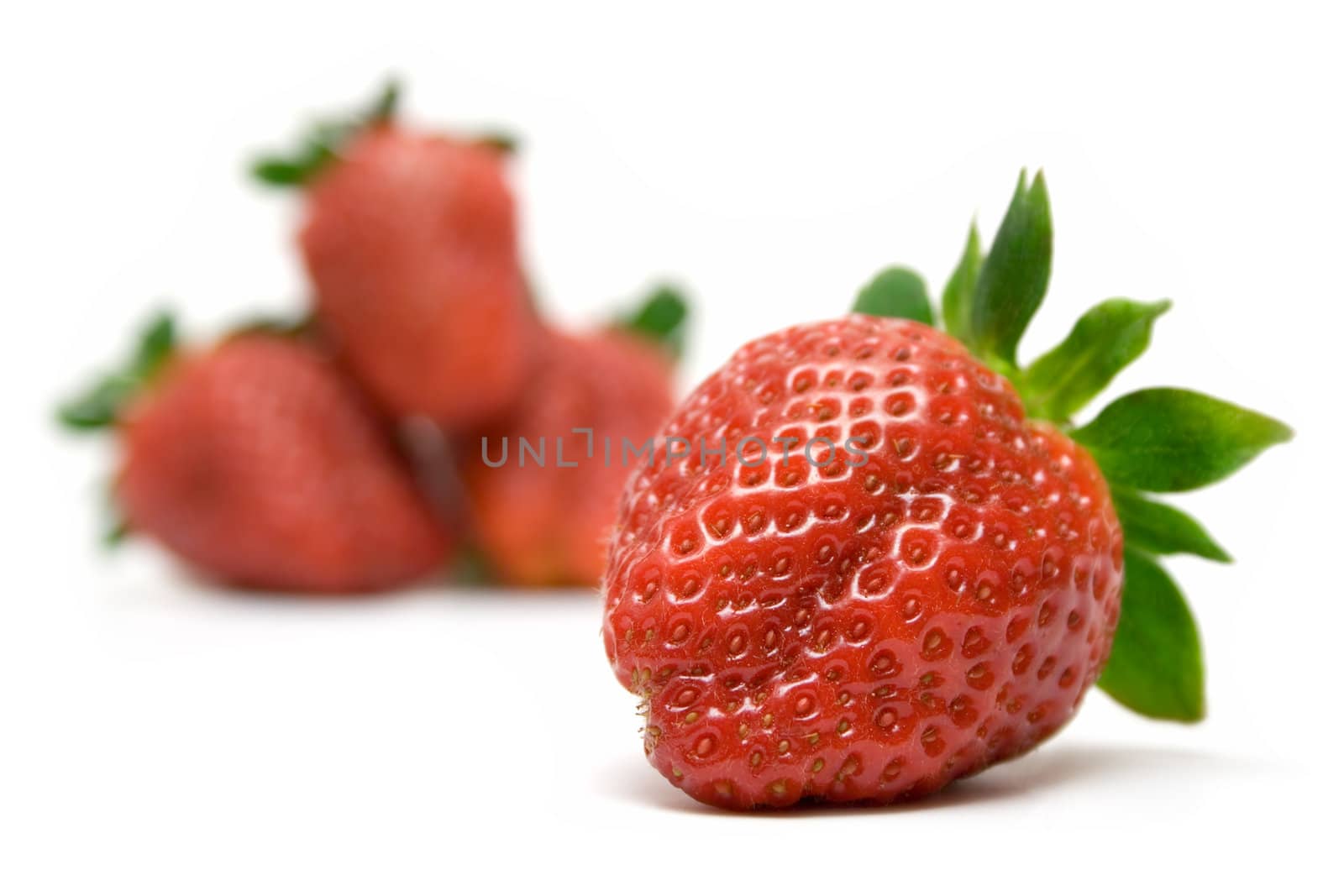 Bunch of Strawberries. Front one focused. Isolated on a white background.