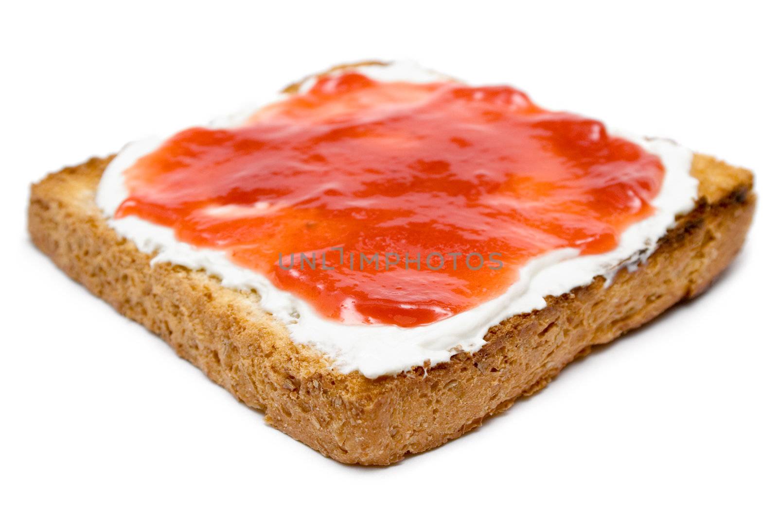 Butter and jam on a warm slice of bread. Isolated on a white background. Shallow depth of field.