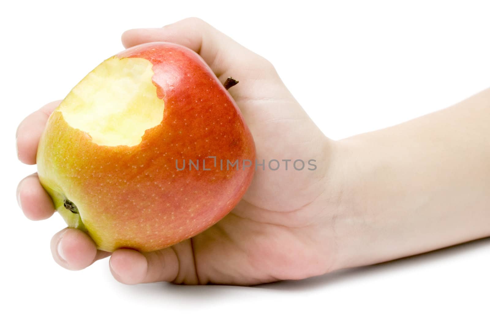 Female hand holding a delicious colorful apple. Isolated on a white background.