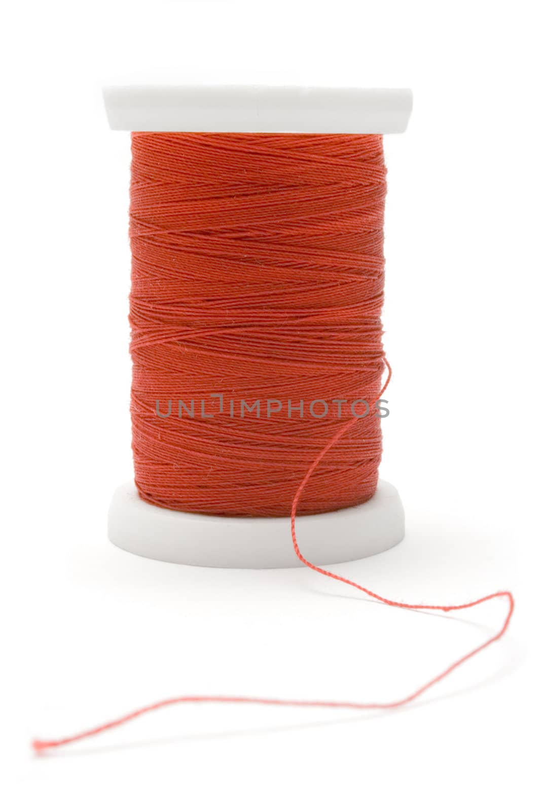 Spool of red thread isolated on white.