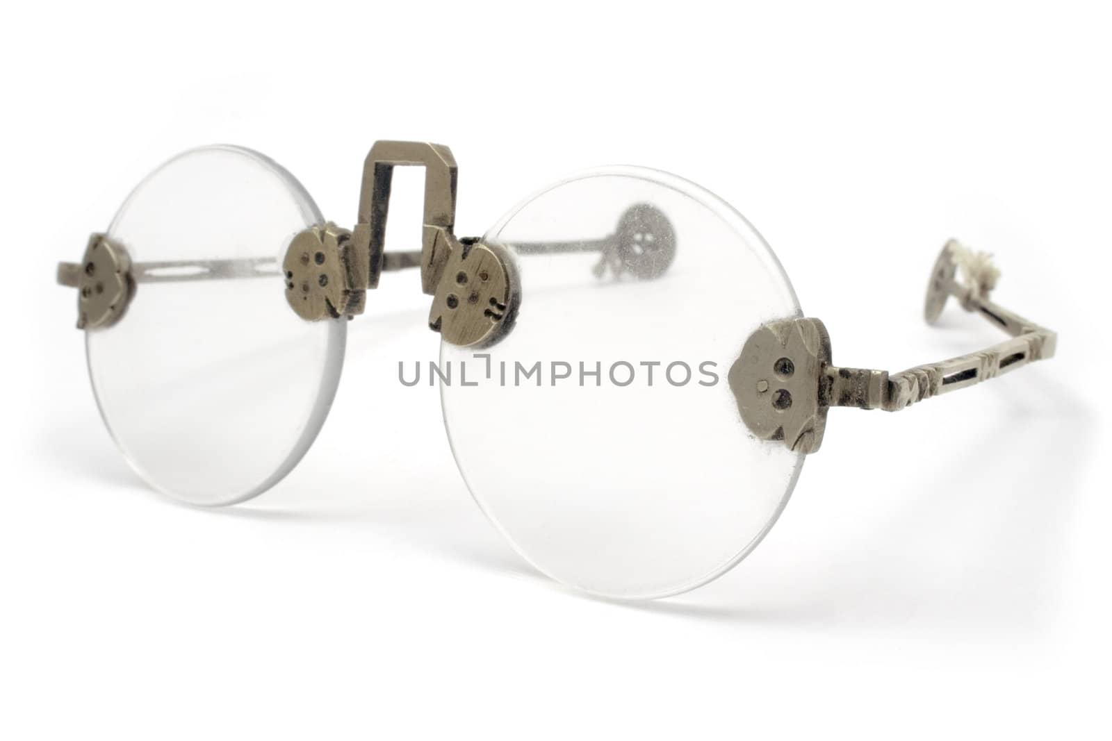 Old and grungy eyeglasses. Isolated on white.