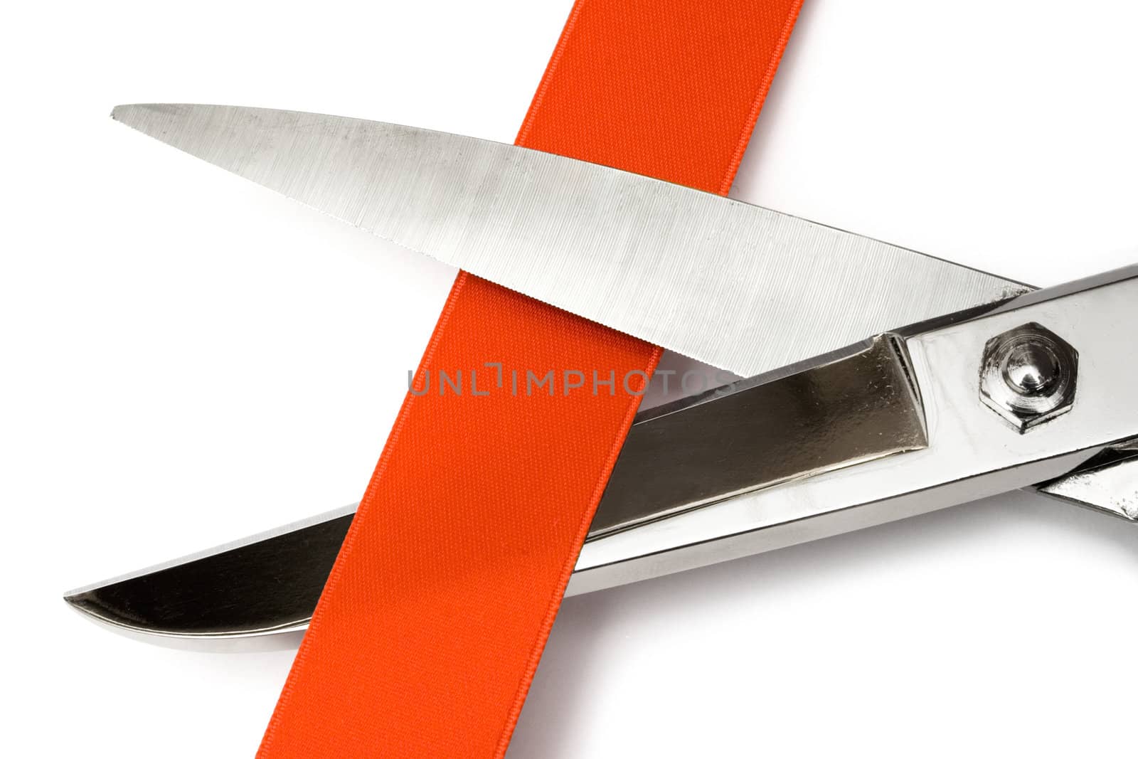 Close-up on scissors cutting a red satin ribbon. Isolated on a white background.