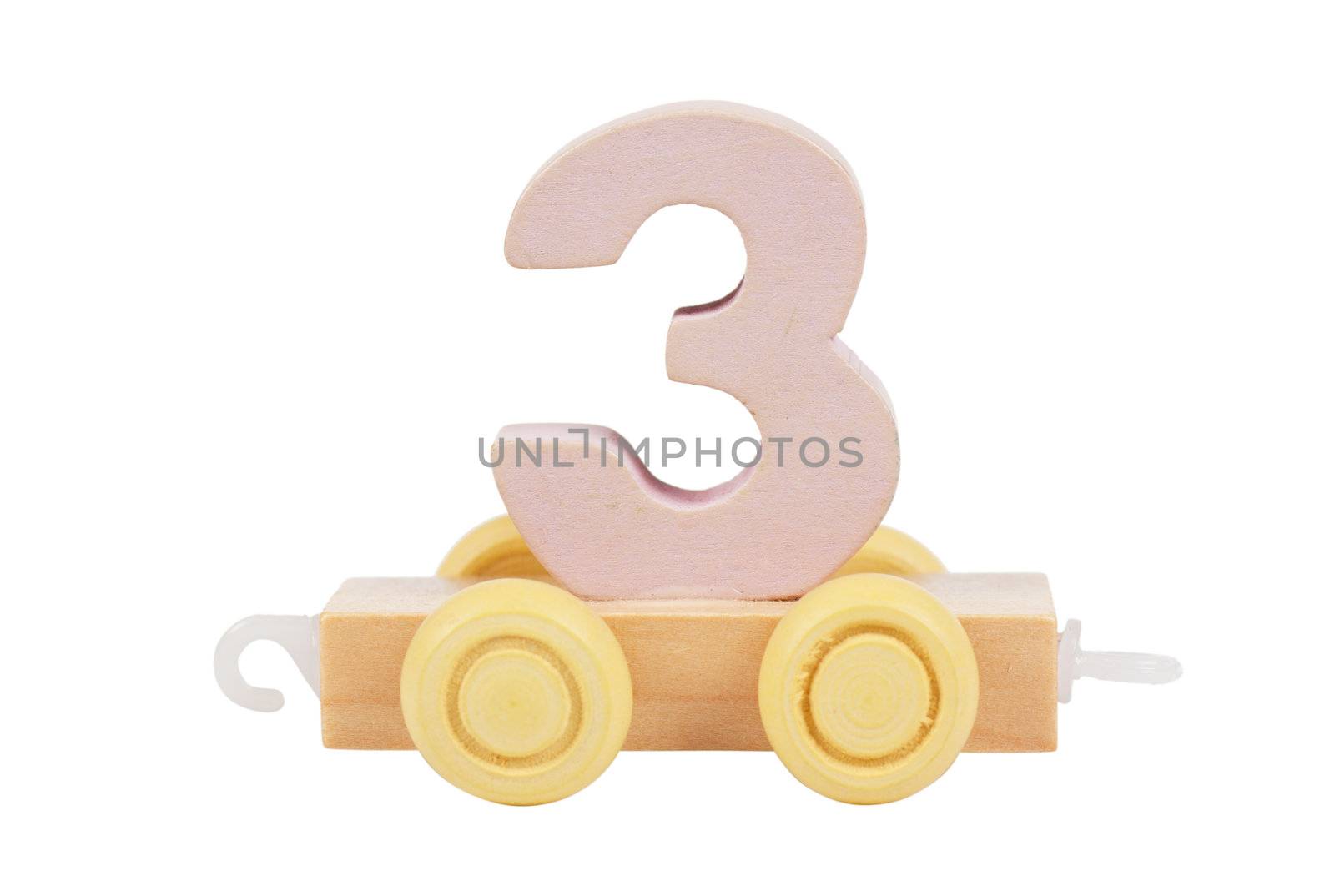 Wooden toy on a wheels number 3 isolated over white