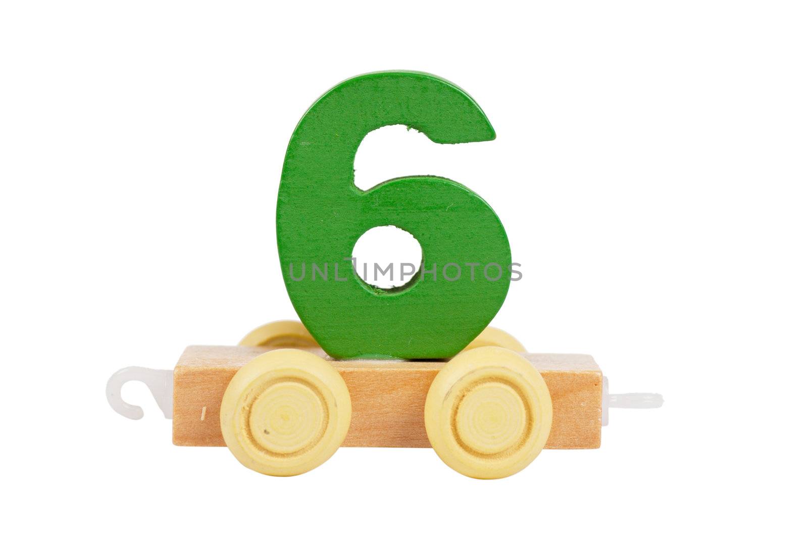 Wooden toy on a wheels number 6 isolated over white